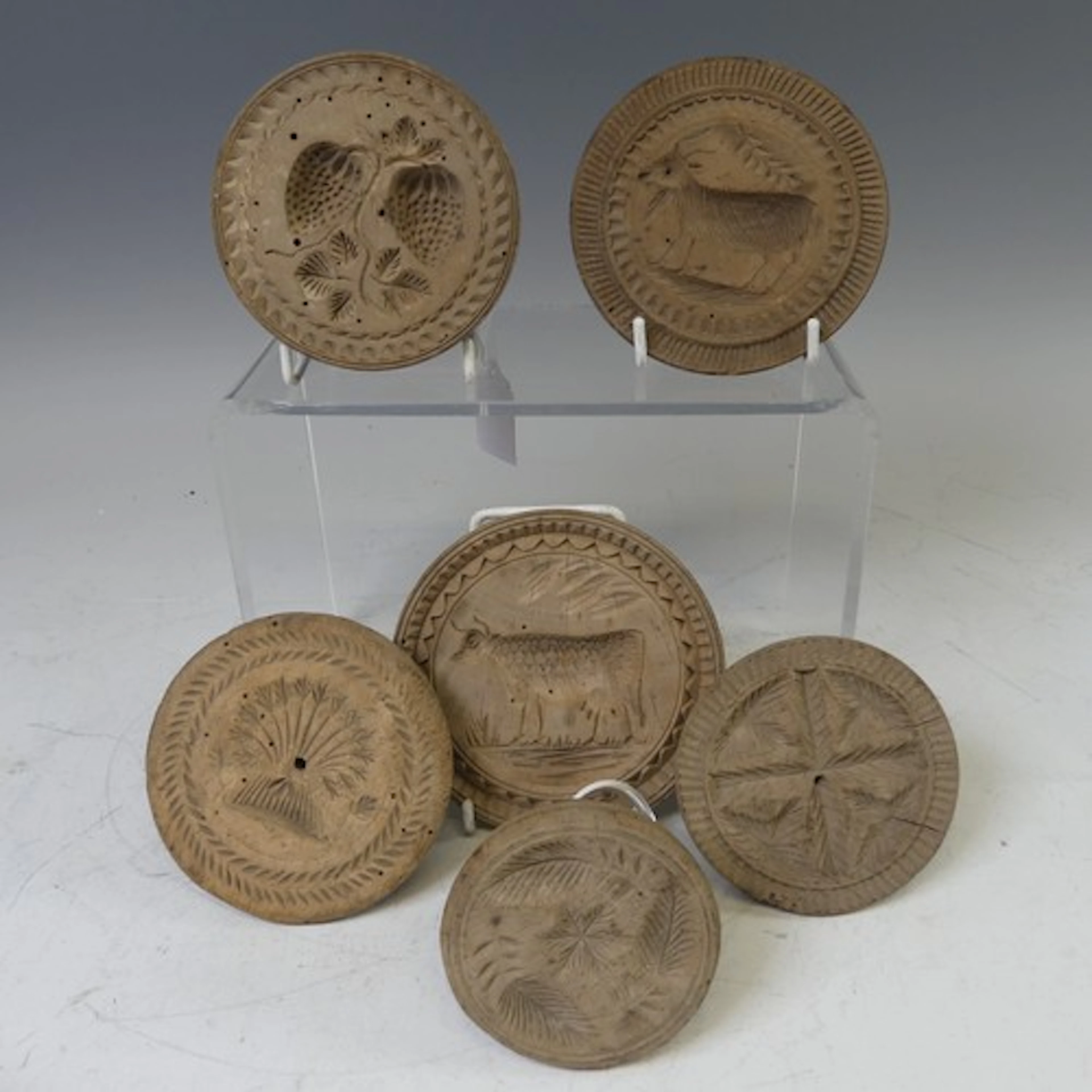 Six antique carved wooden butter Moulds, with floral or farm...