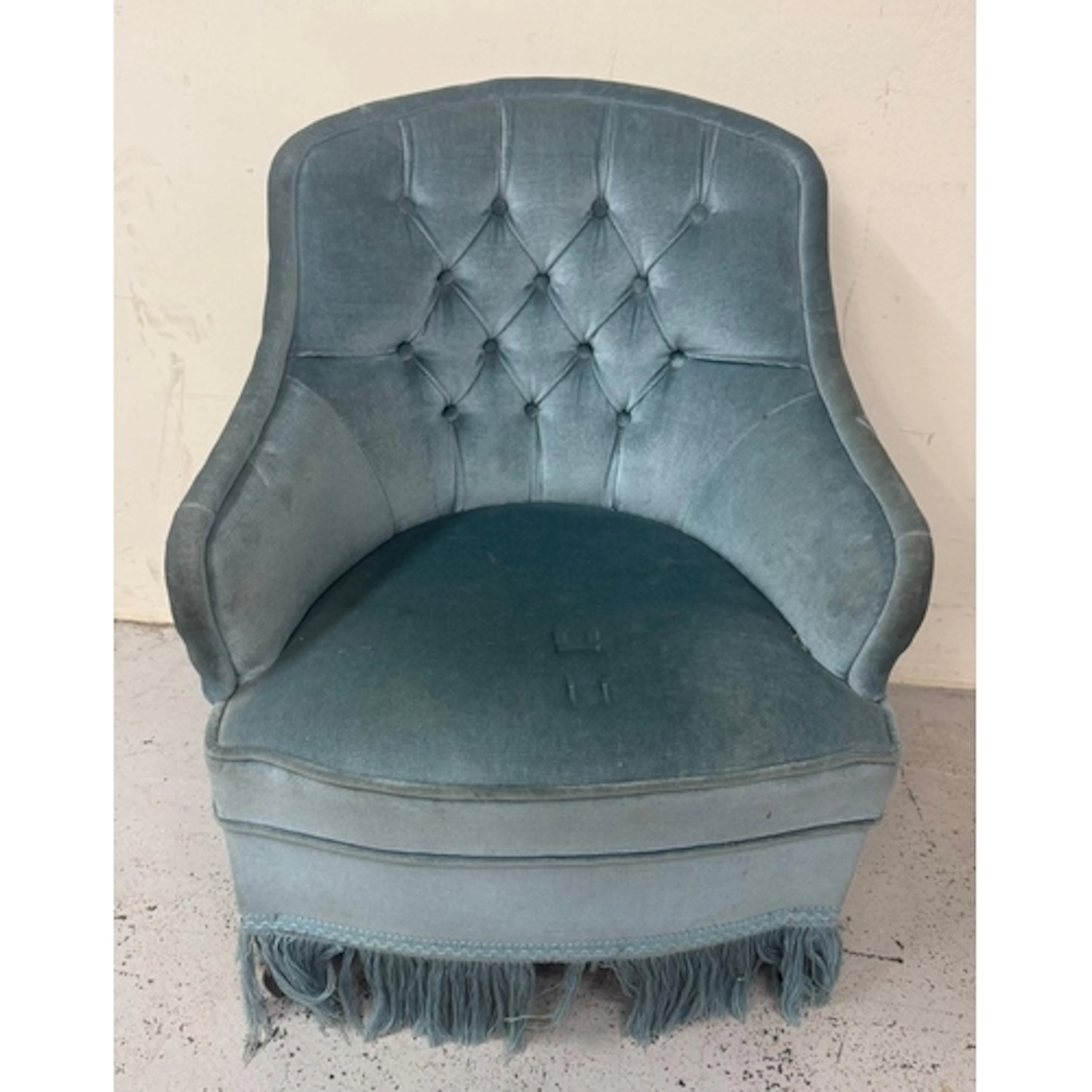 A blue velvet button backed tub chair