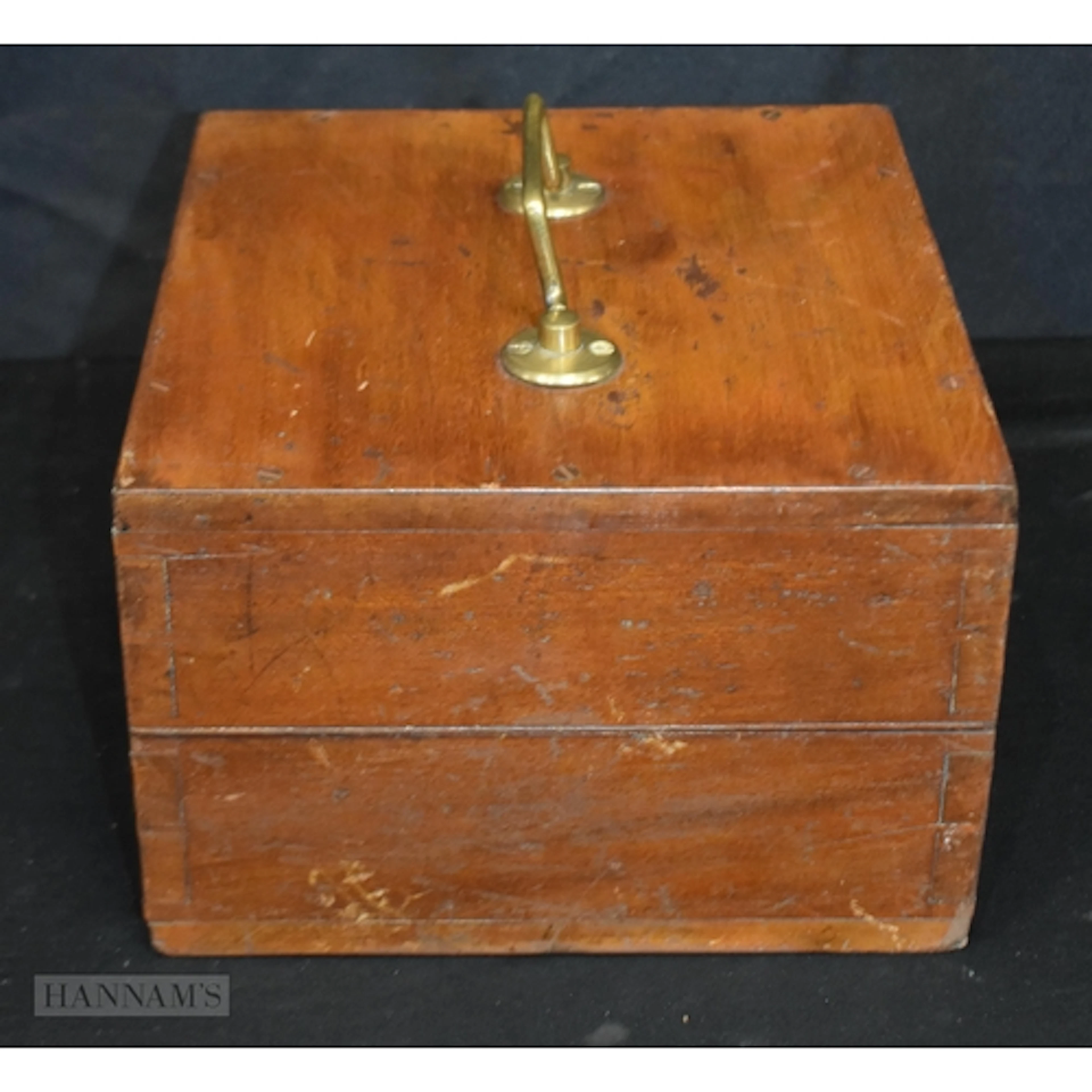 A vintage economic electric company wattmeter in a wooden ca...