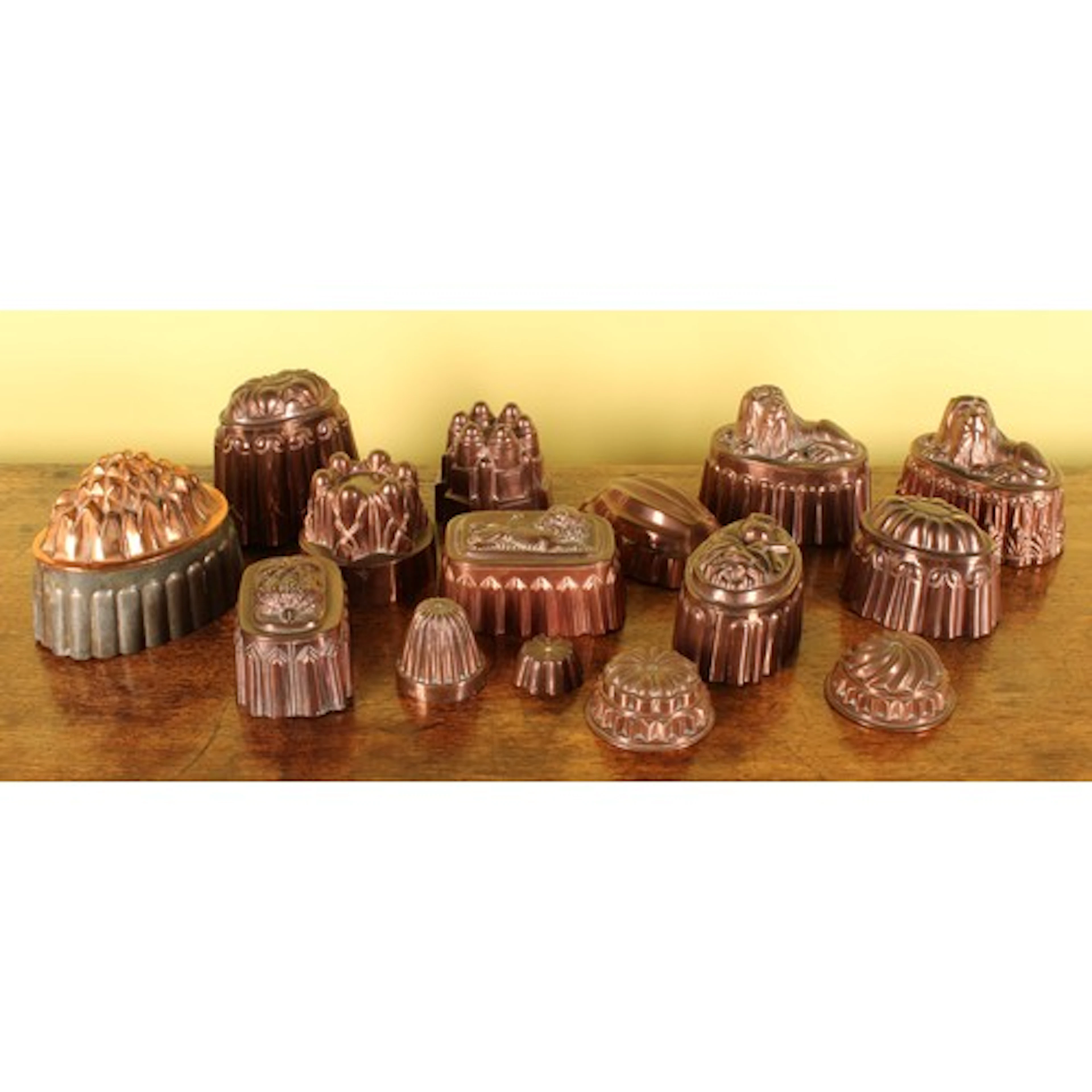A collection of fifteen Victorian copper and tin pudding or ...