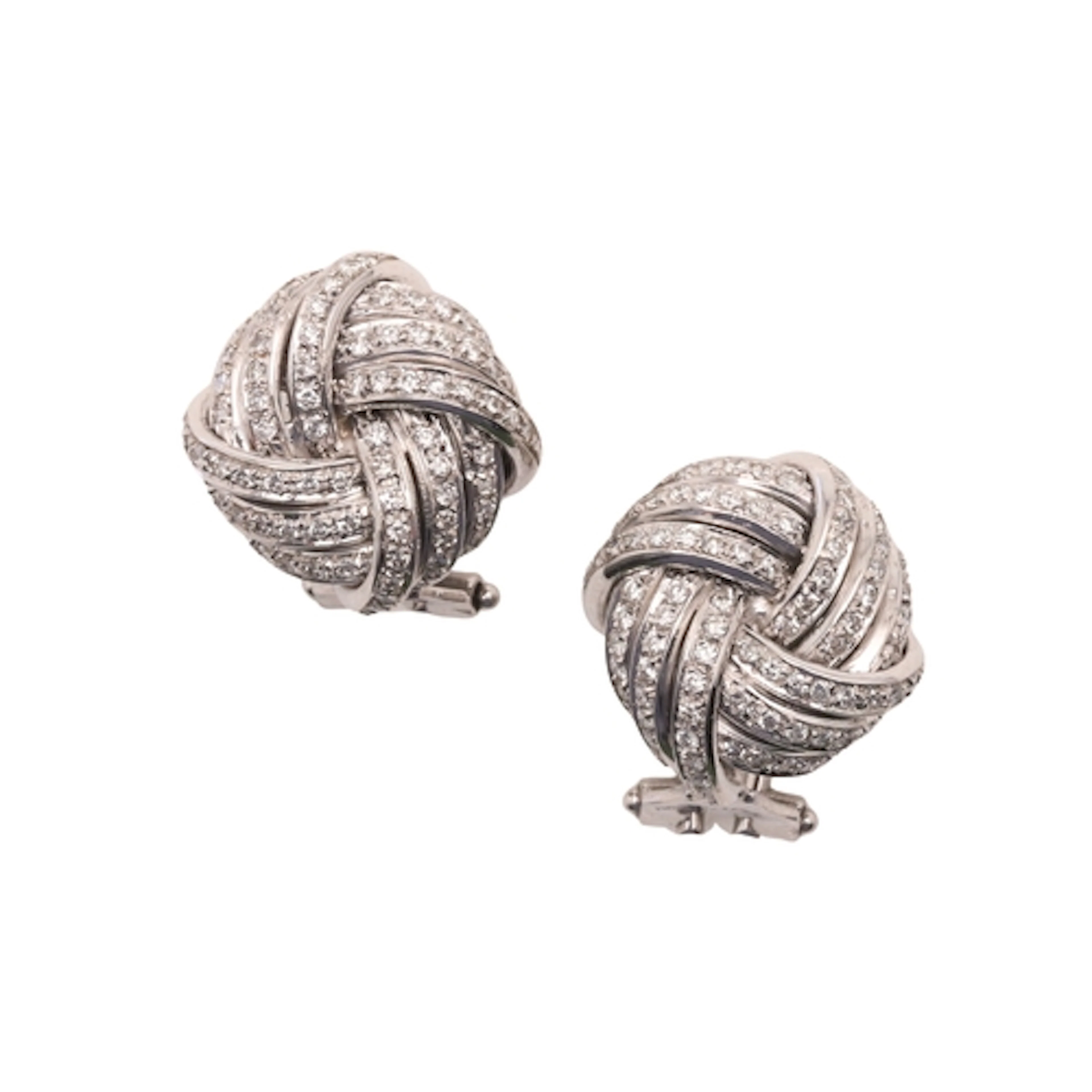 A PAIR OF DIAMOND EARRINGS. of knot design, set throughout w...