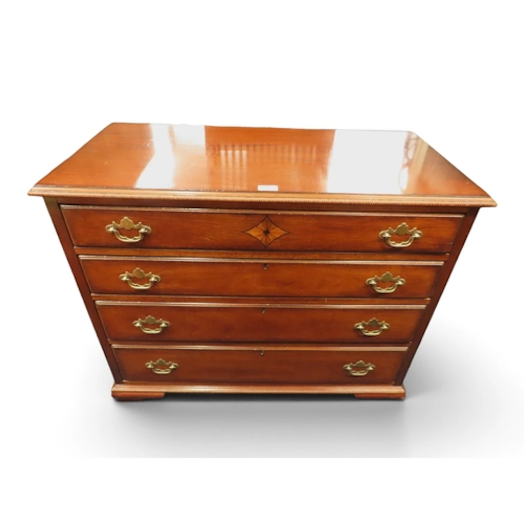 A 20th century mahogany chest of drawers with four long grad...