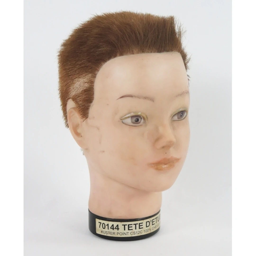 A French rubber dummy boy's head with short cropped hair. 27...