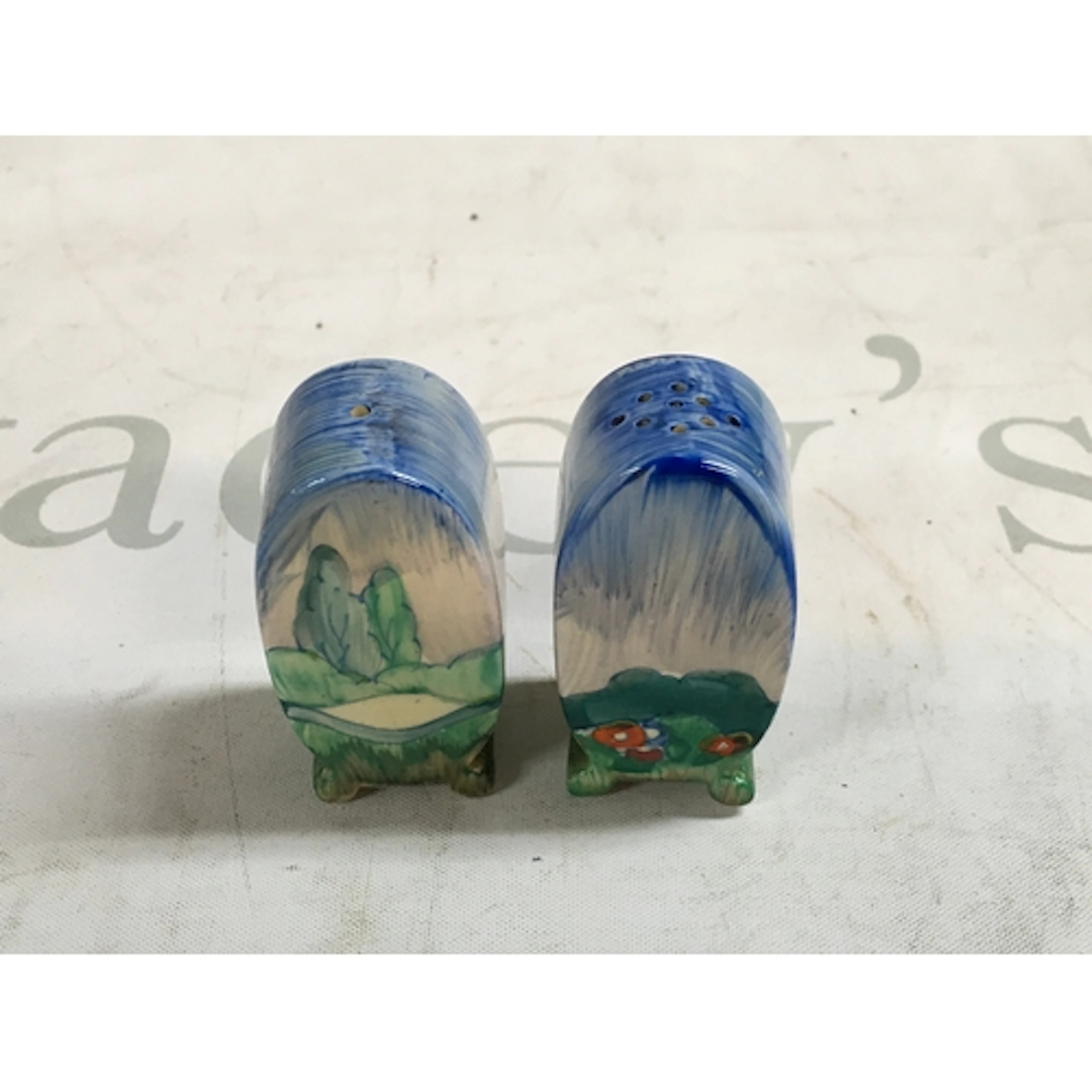 A pair of hand painted Clarice Cliff salt and pepper shakers...
