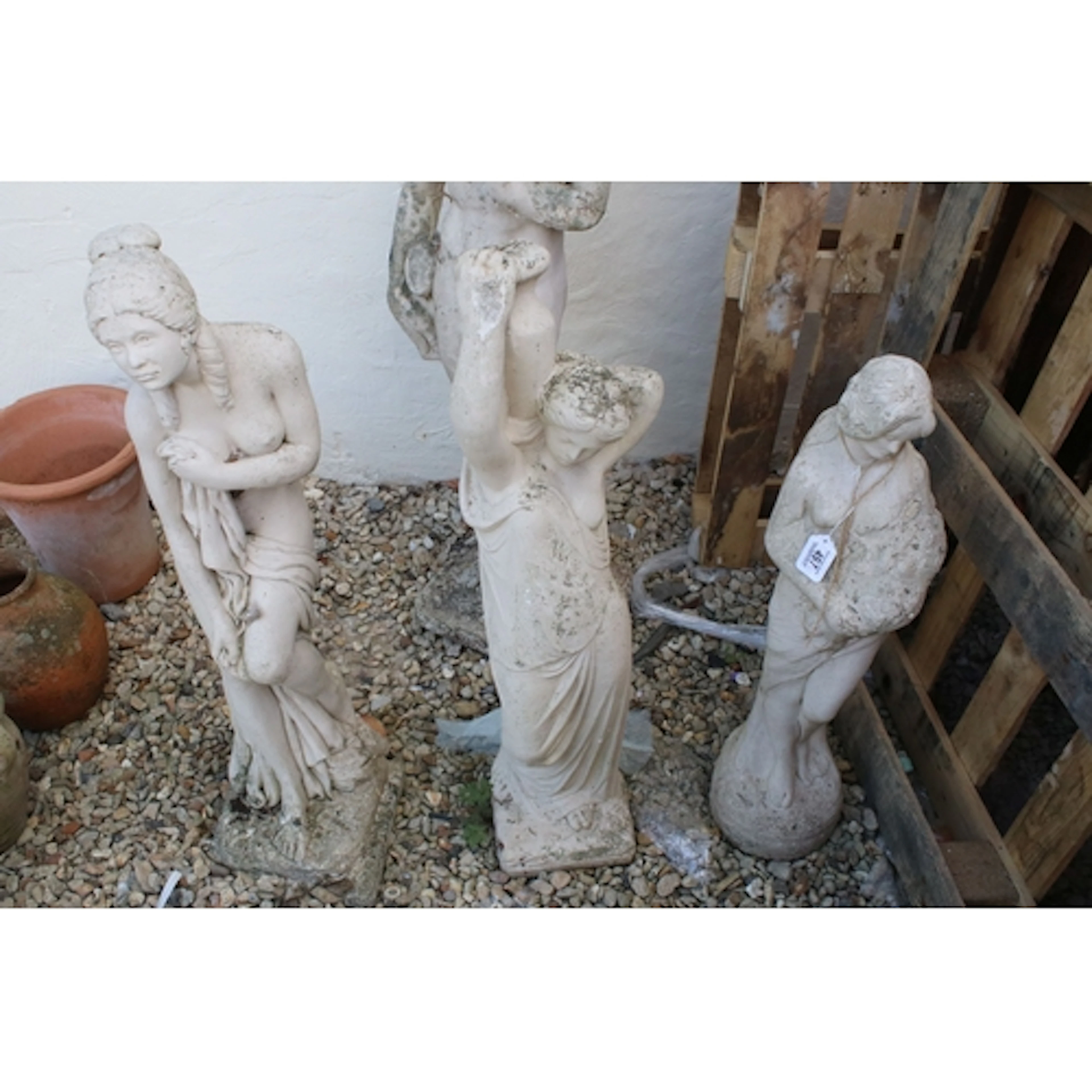 Three reconstituted stone garden ornaments in the form of th...