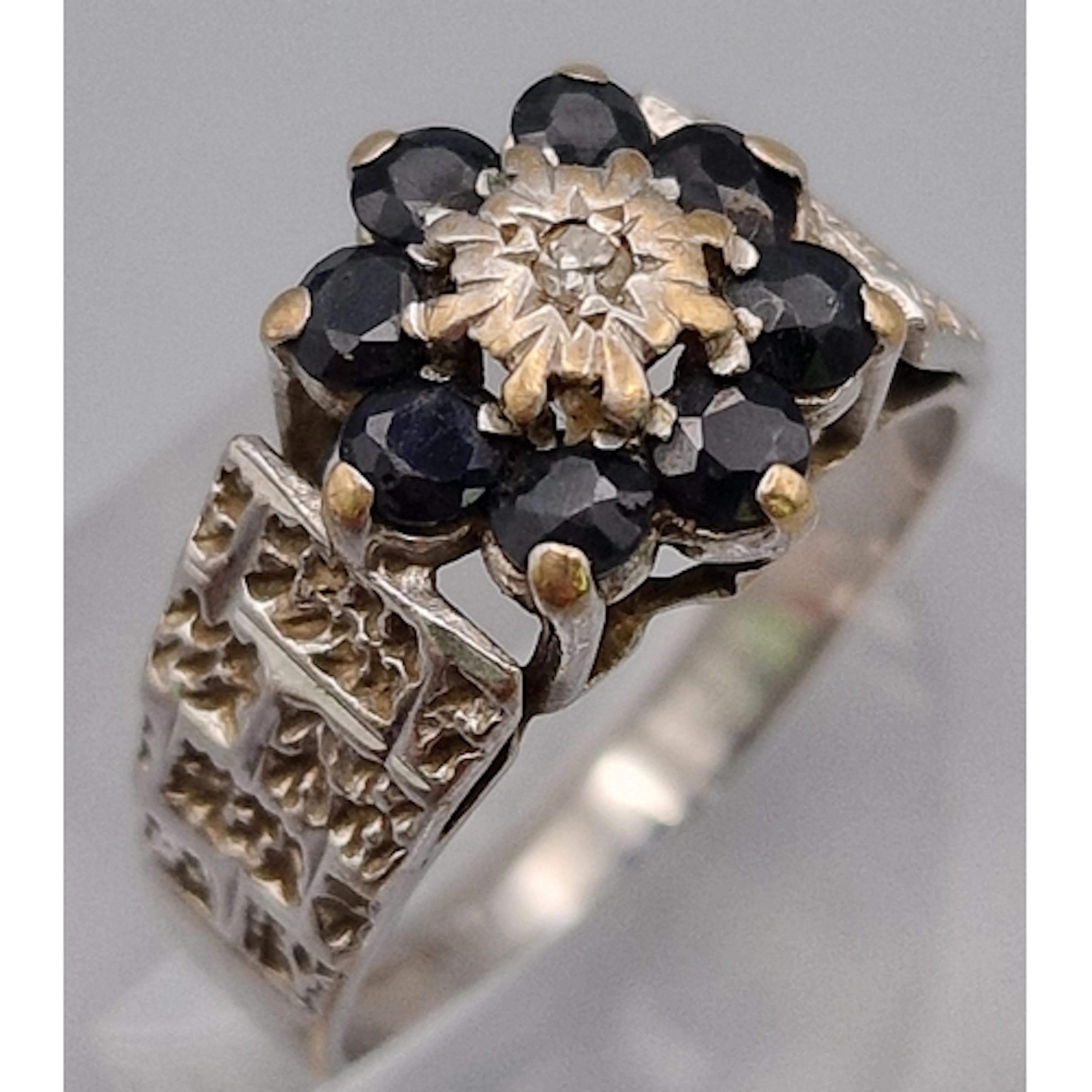 9ct white gold textured sapphire and diamond flowerhead ring...