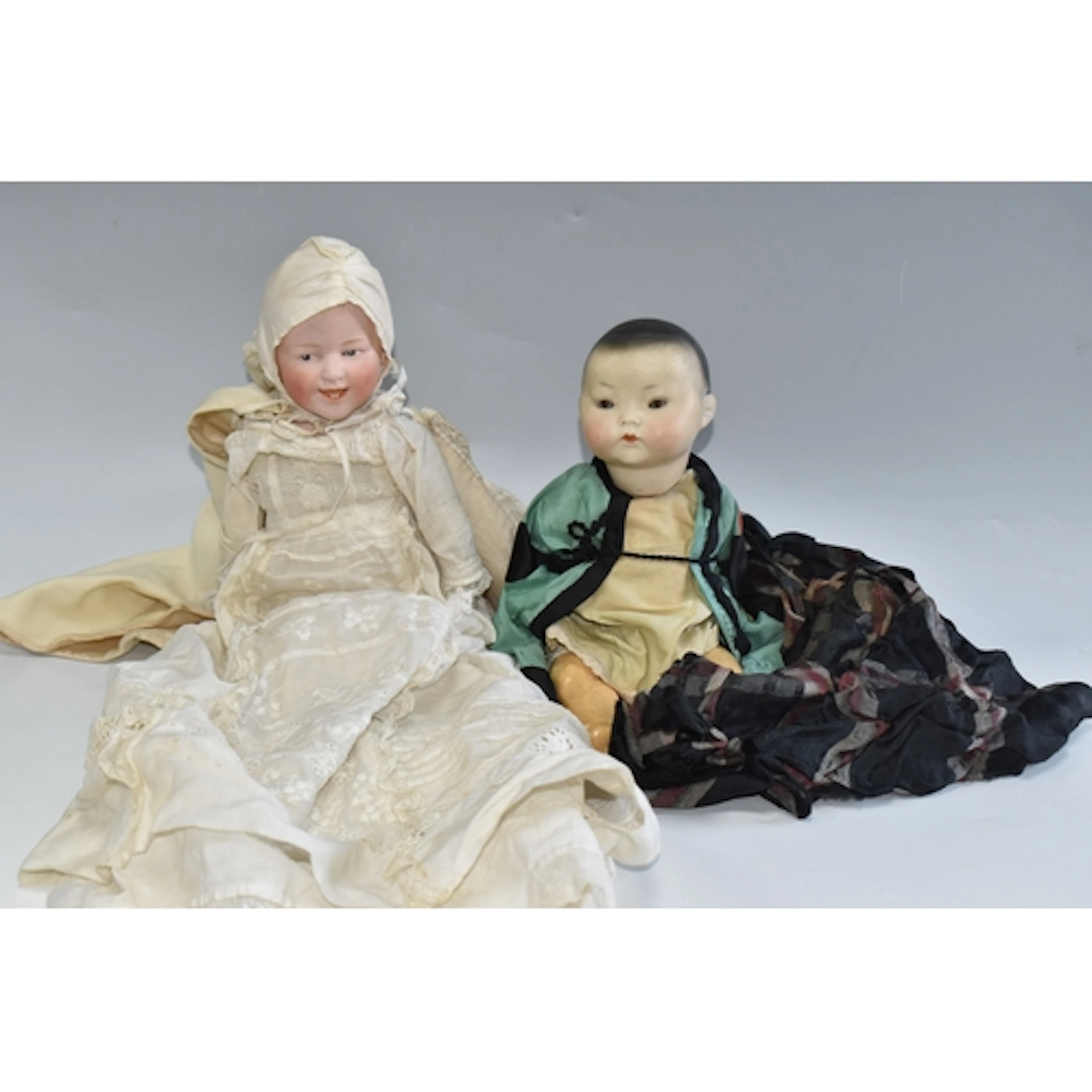 TWO VINTAGE GERMAN PORCELAIN DOLLS comprising a papier mache...