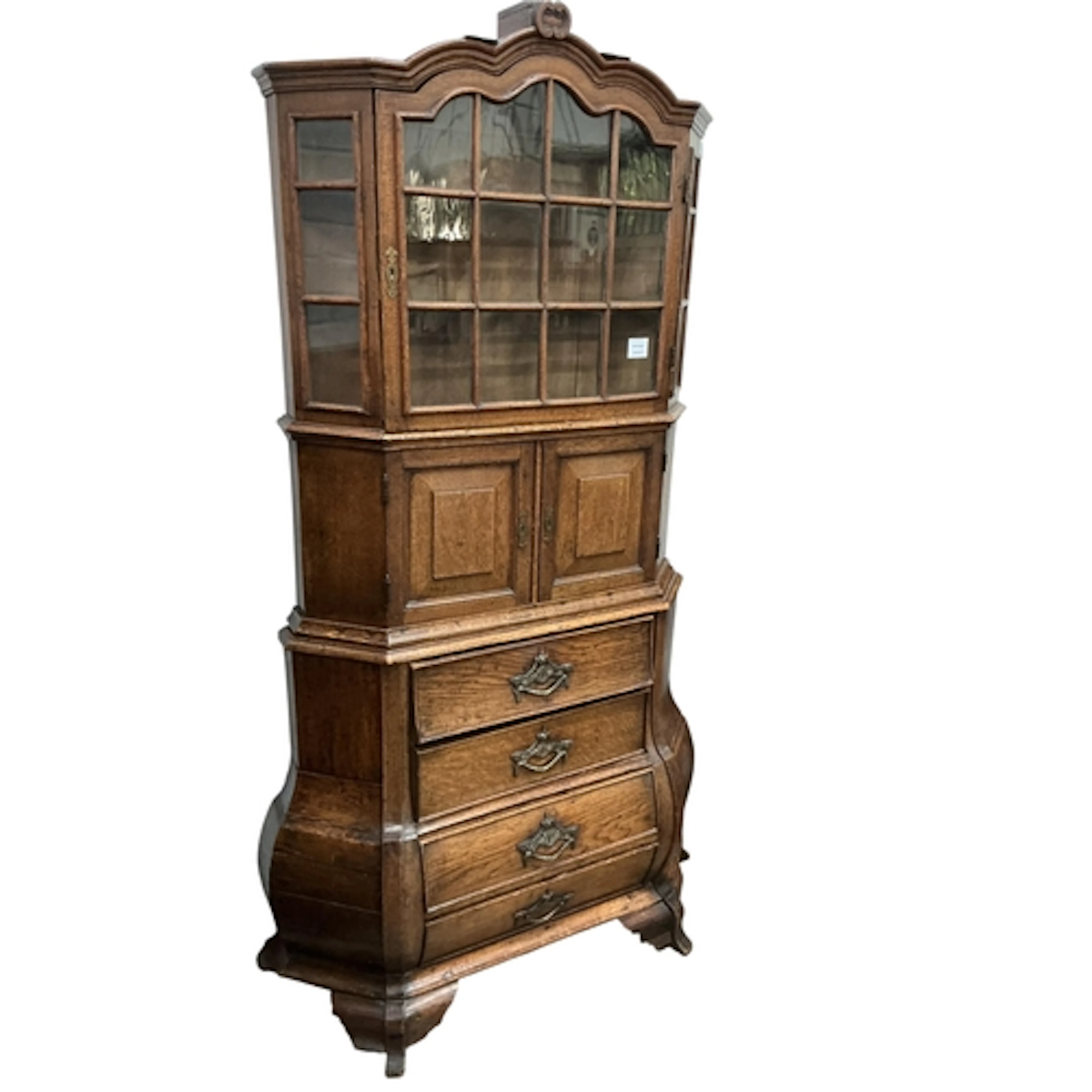 An 18th century Dutch oak bombe cabinet on chest, width 103c...