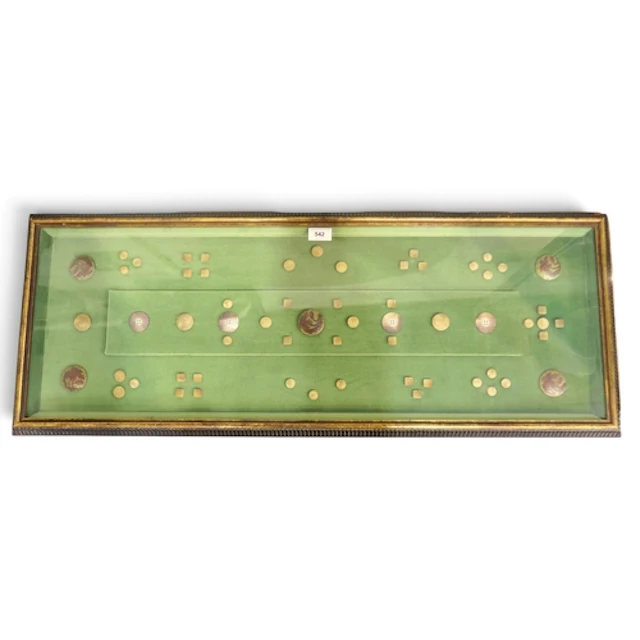 An unusual framed display of antique North American buttons,...