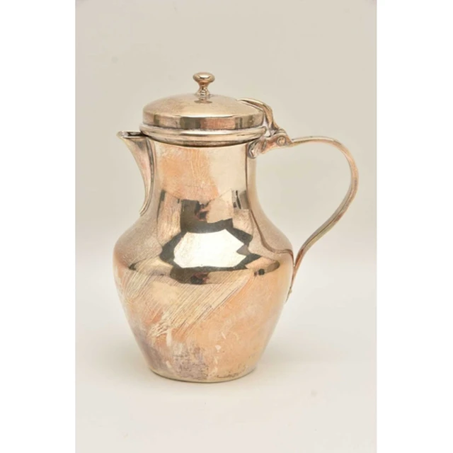 A LATE VICTORIAN SILVER JUG, polished form with scroll handl...