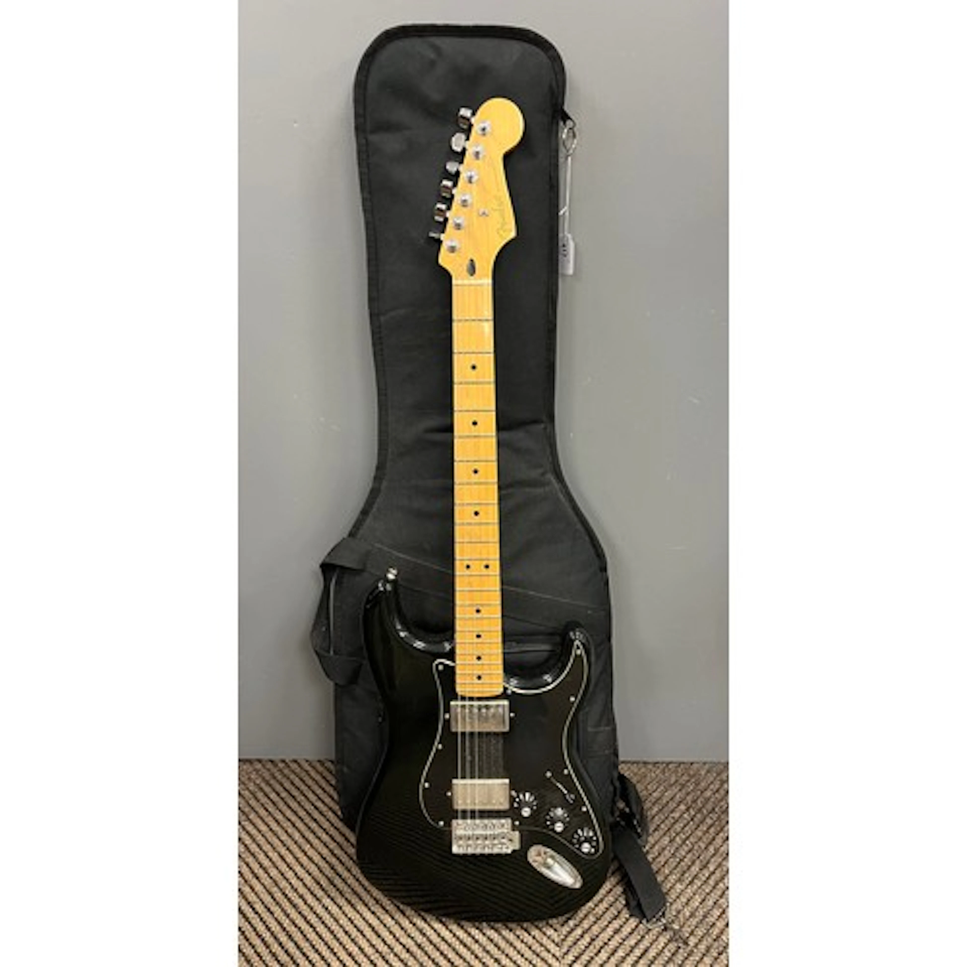 Mexican electric guitar, with soft carrying case.