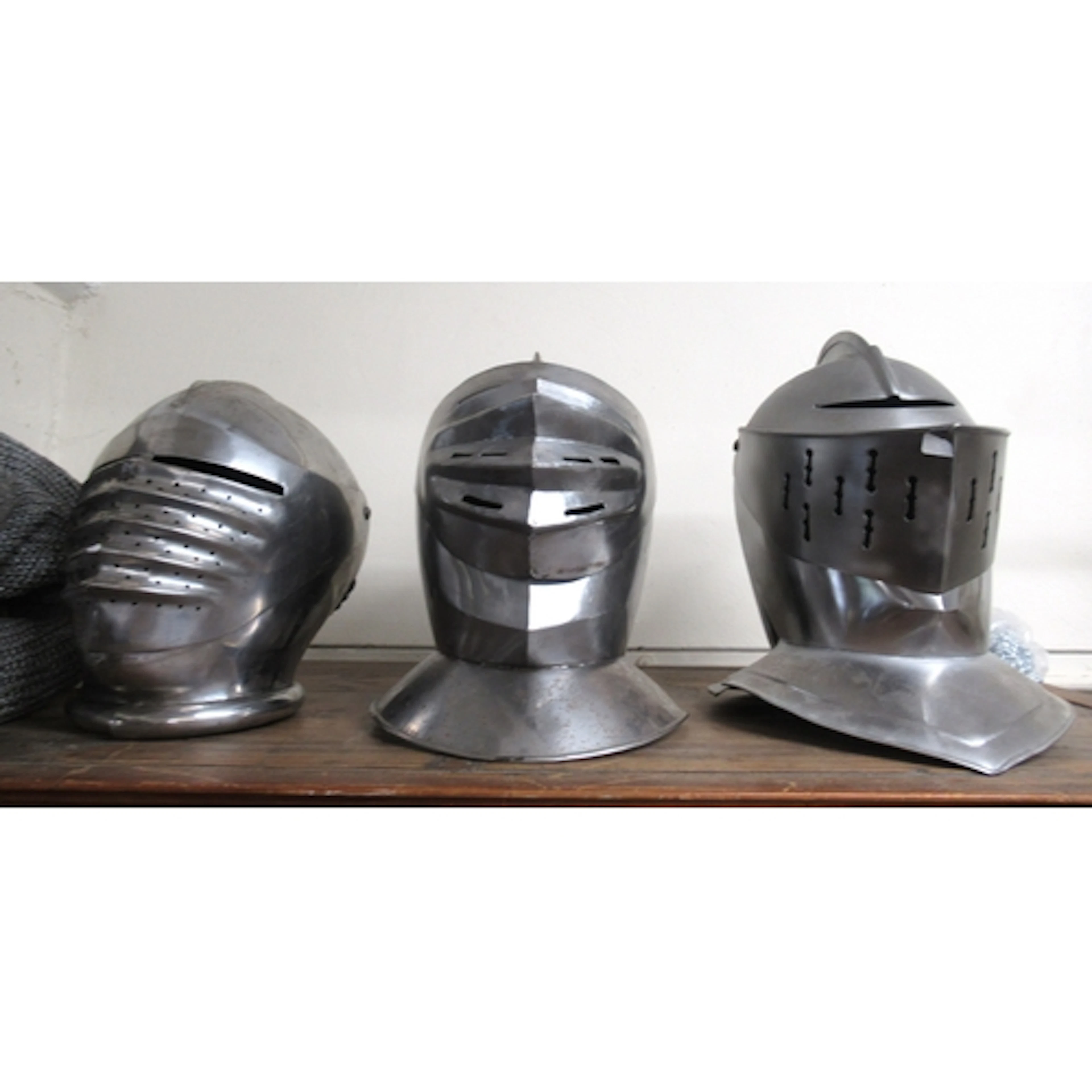 Group of three medieval style steel armour helmets, together...