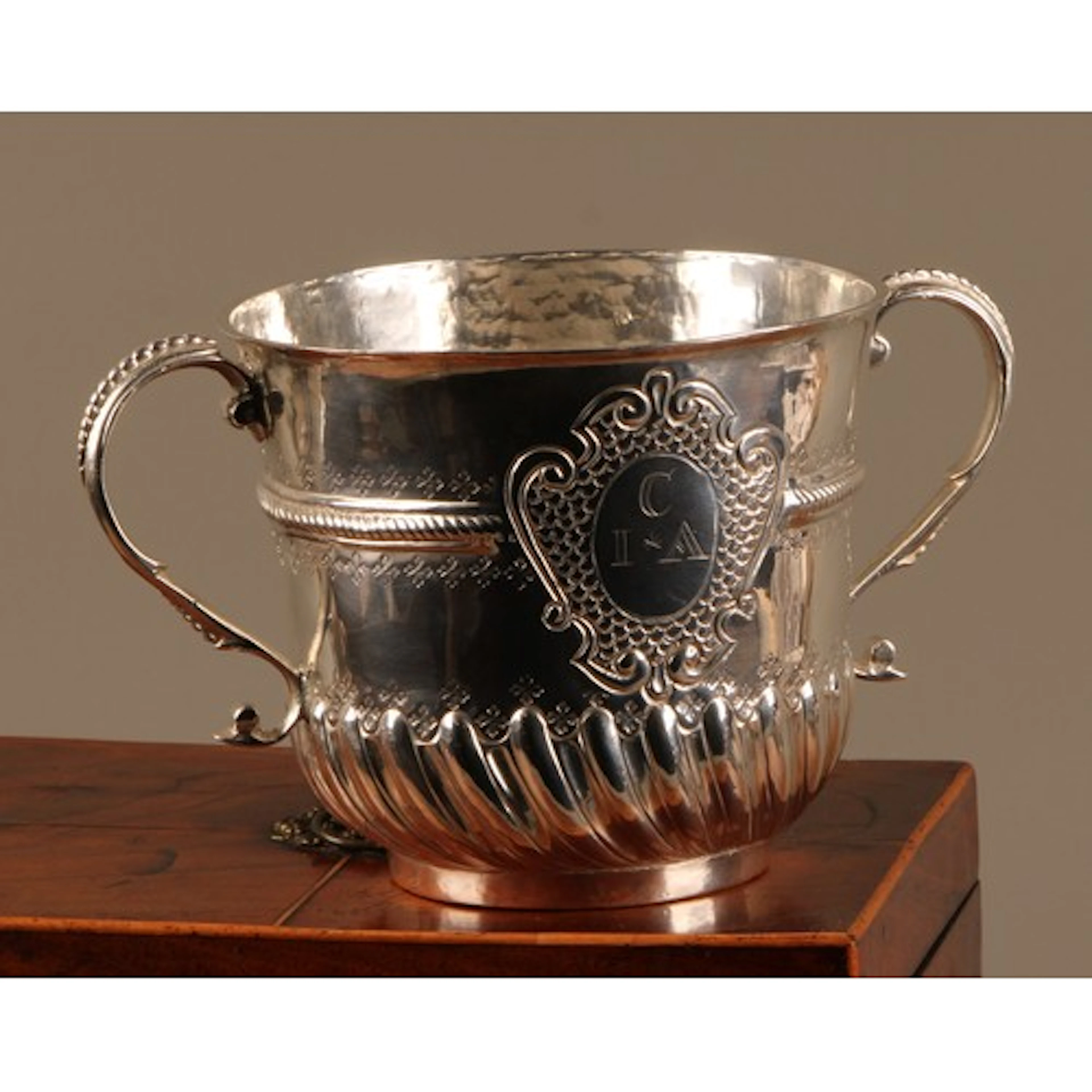 A Queen Anne silver porringer, beaded scroll handles, fluted...
