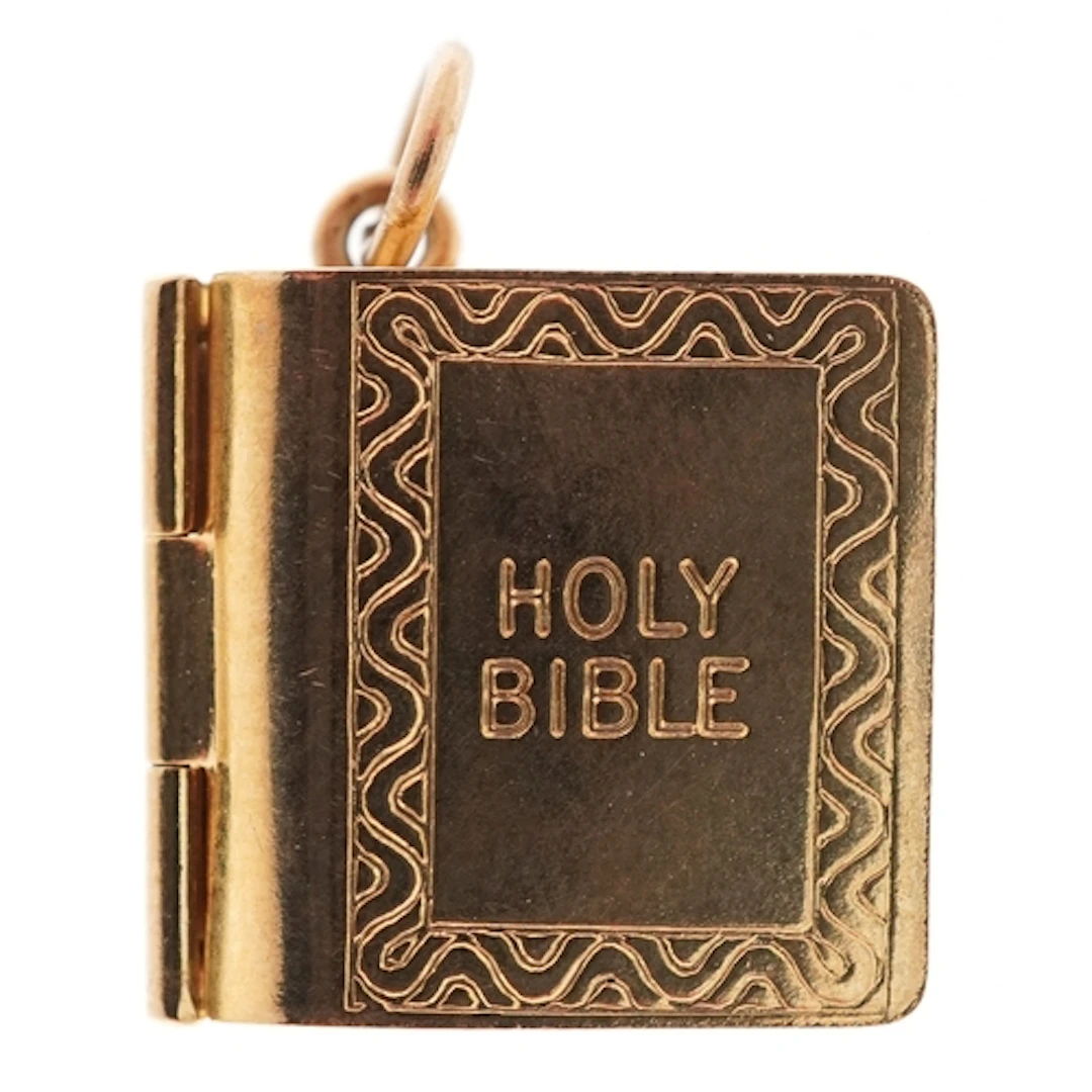 9ct gold charm in the form of the Holy Bible with paper page...