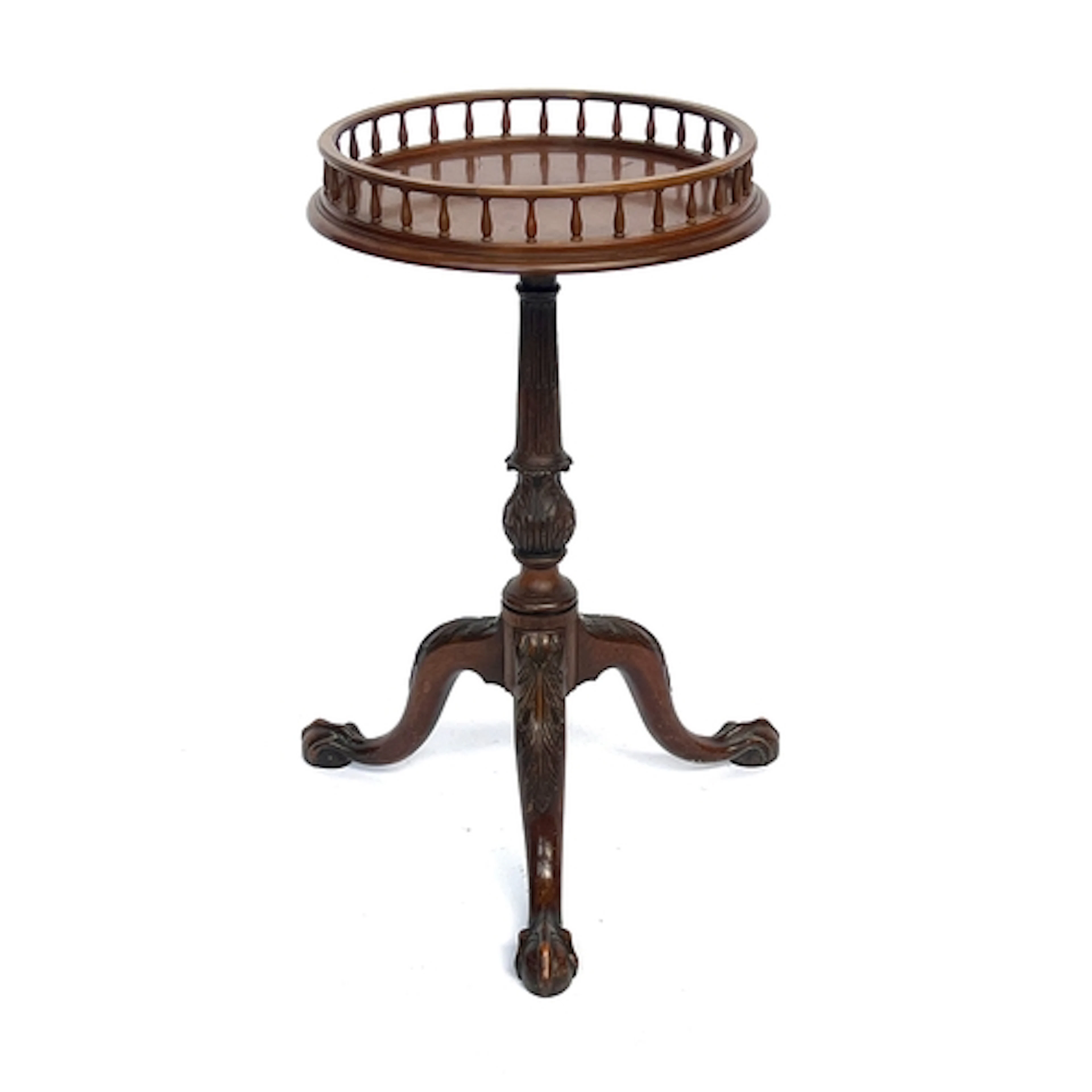 A circular galleried mahogany lamp table, 20th century, on c...