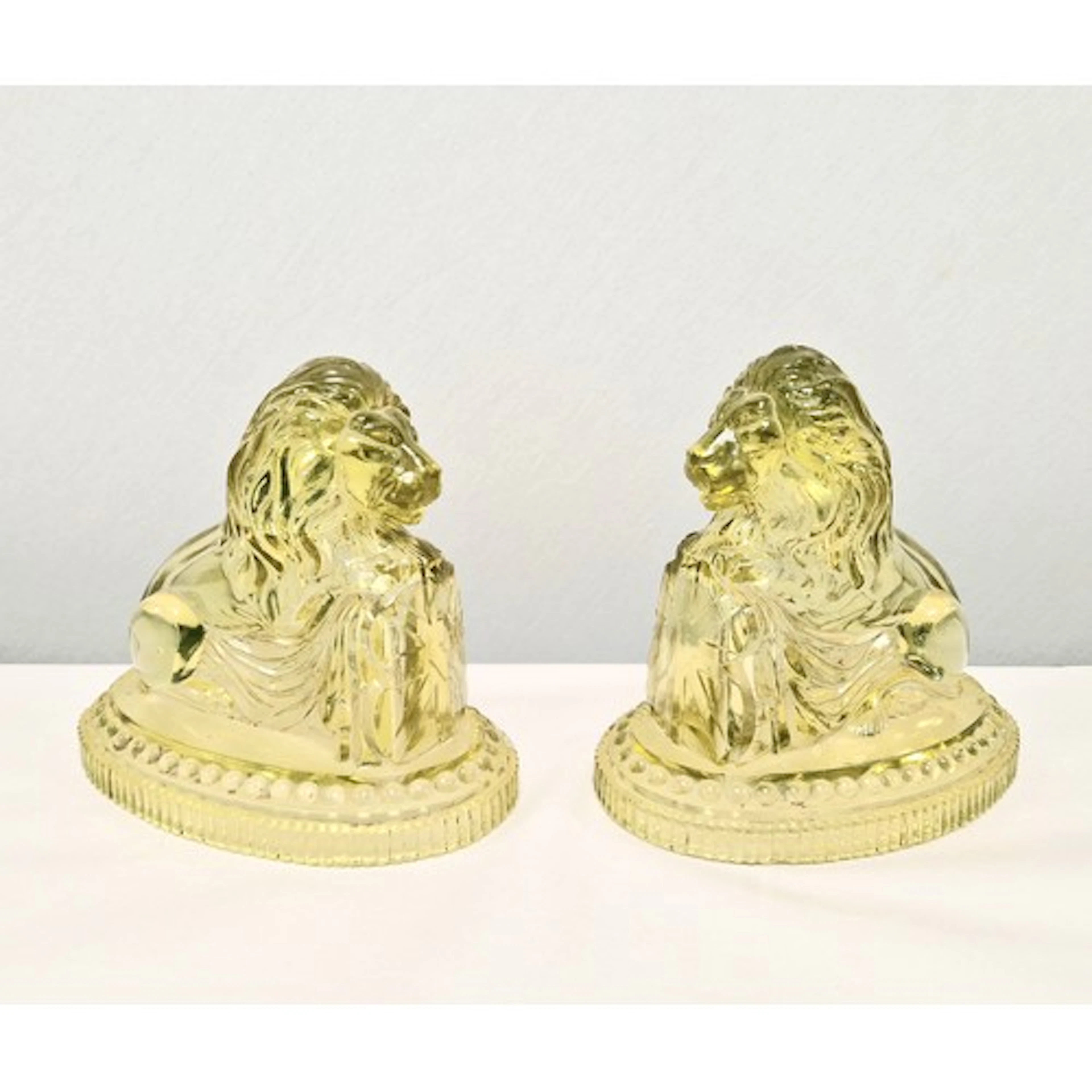 Pair of pressed Uranium glass figures of lions in the manner...