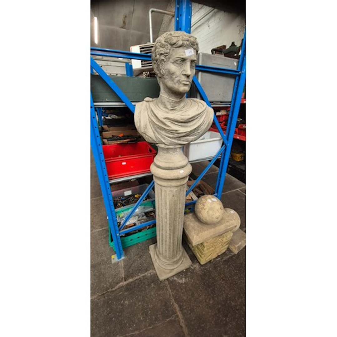 A concrete classical Roman bust on a concrete Doric style pe...