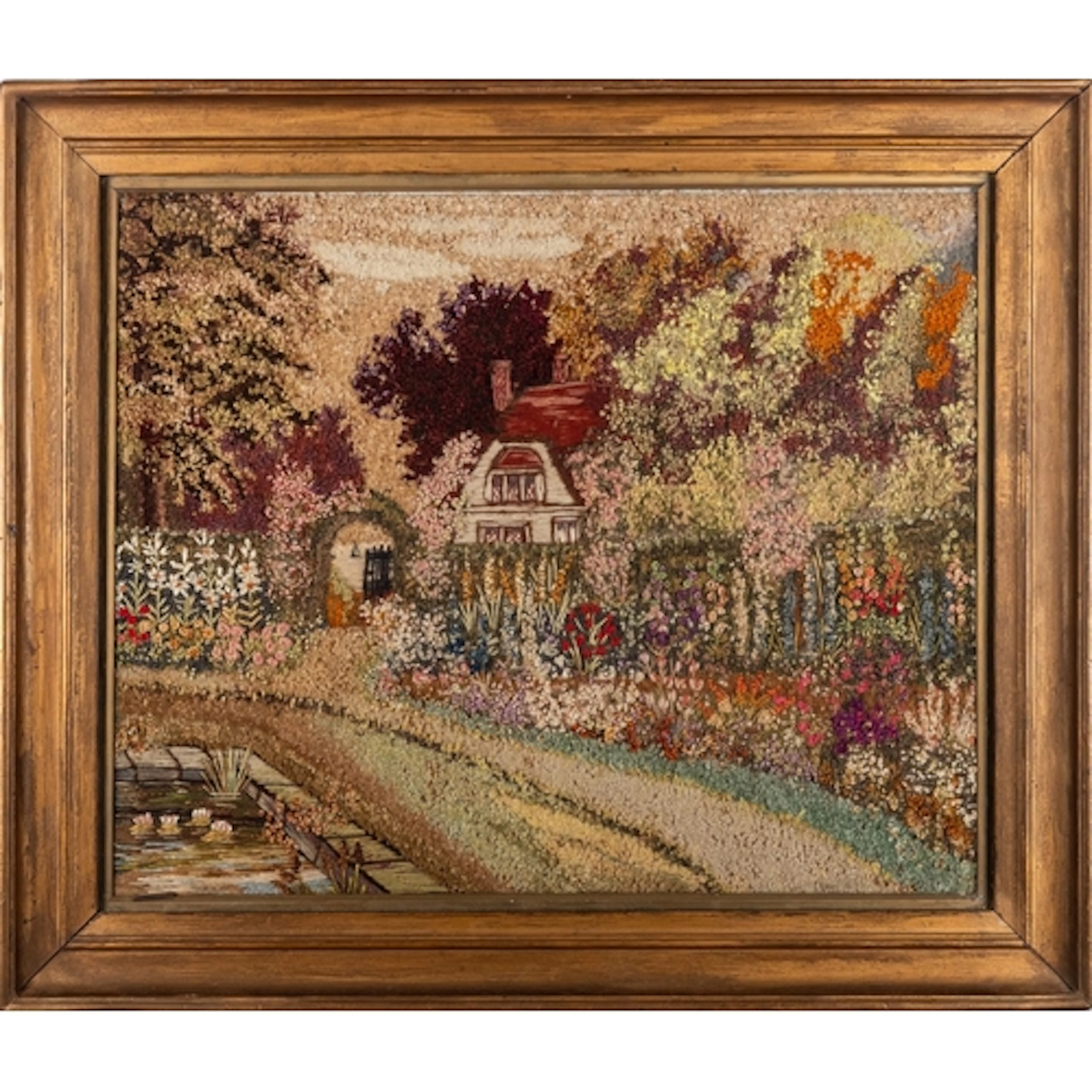A Victorian folk art woolwork picture of a cottage garden, i...