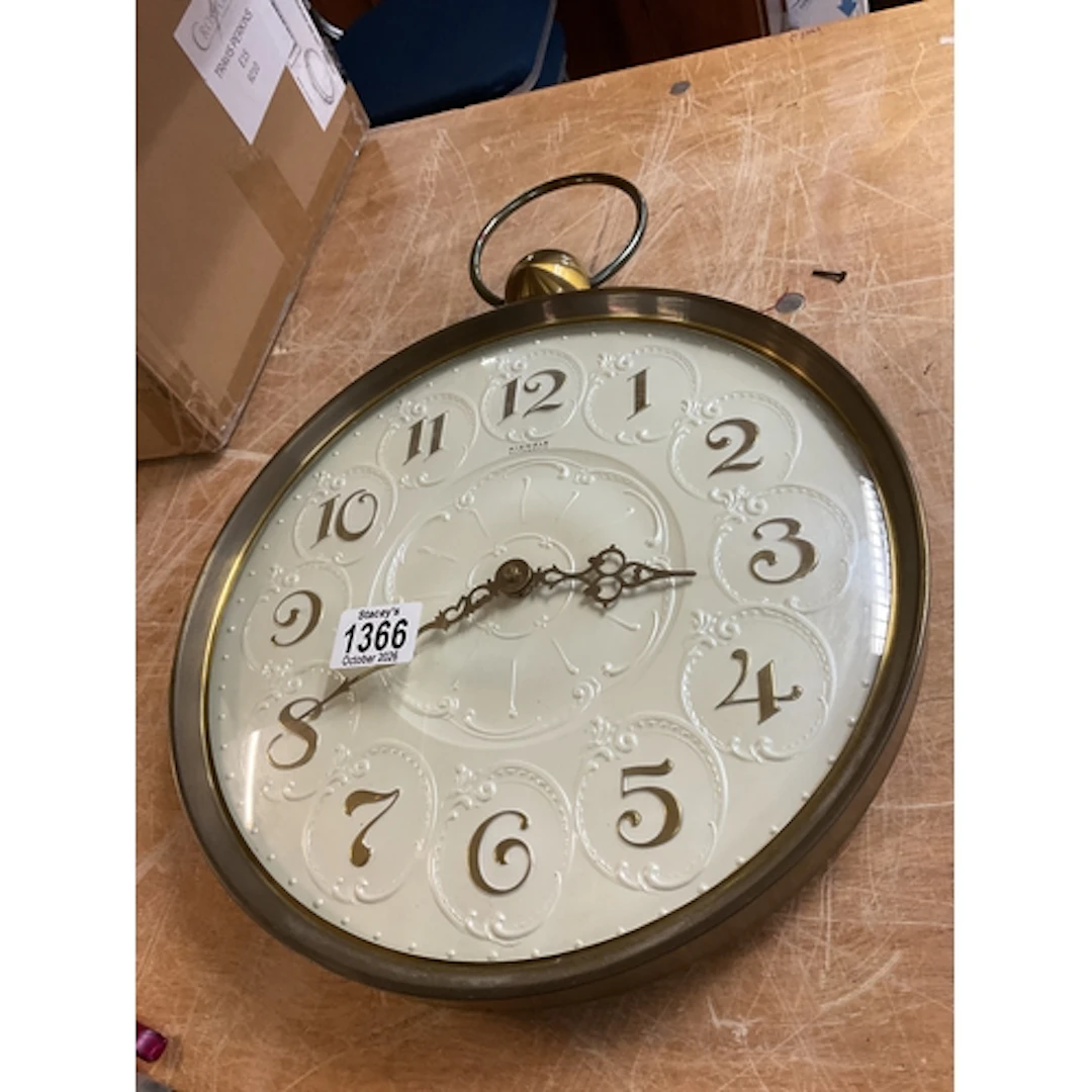Kienzle wall clock with pearlized ornate face.