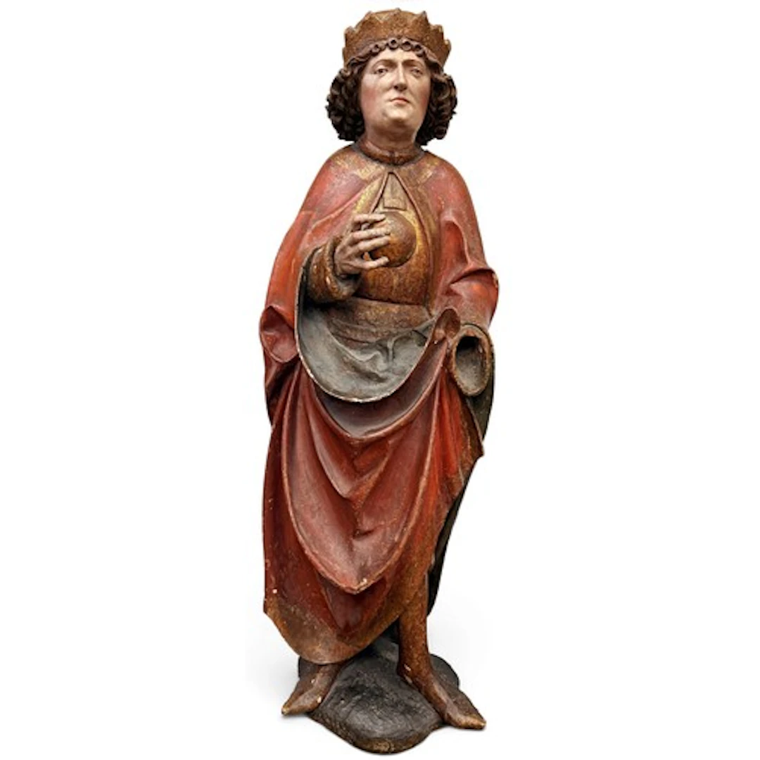A fine gilt and polychromed limewood figure of a saintly kin...