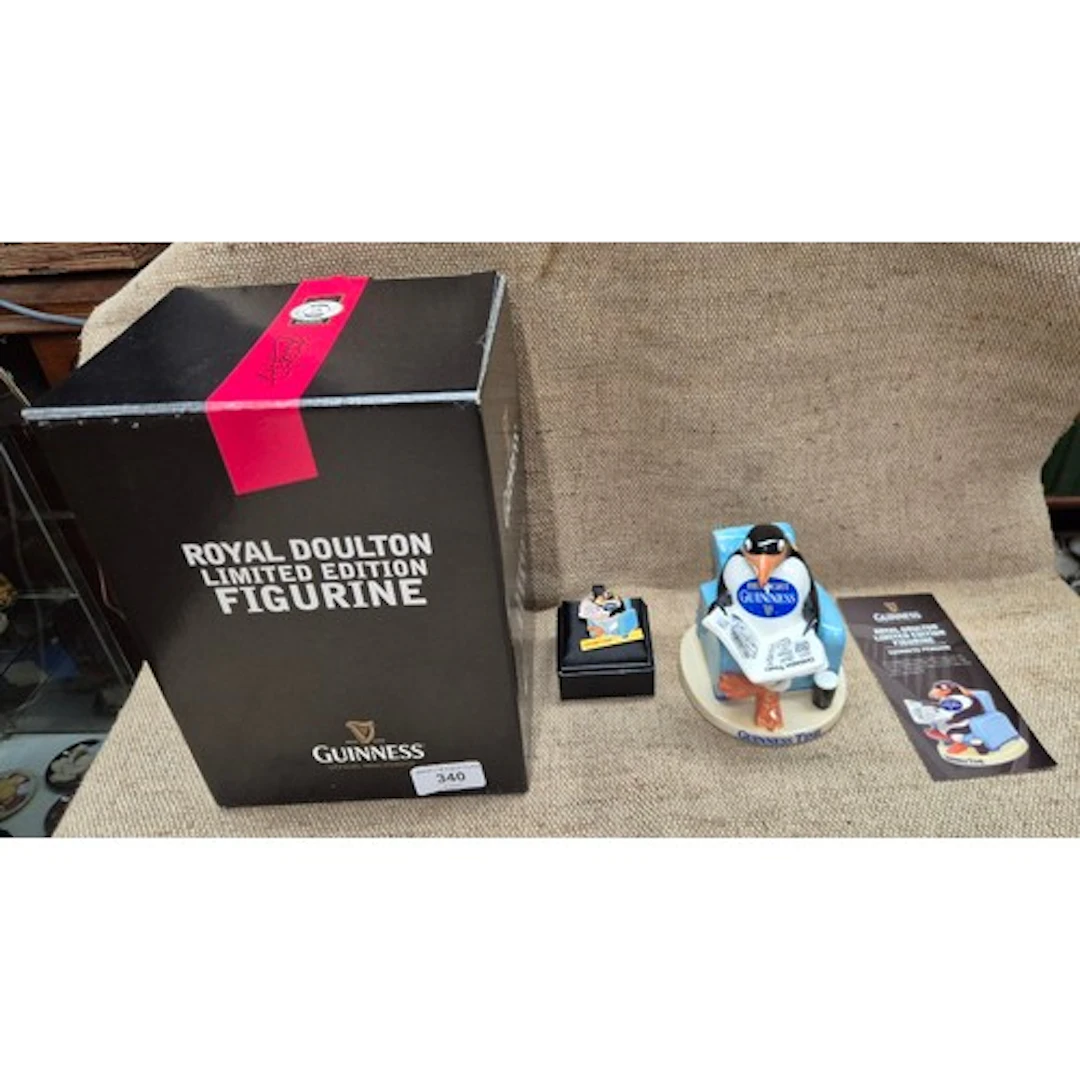 A Royal Doulton limited edition figurine of the Guinness Pen...