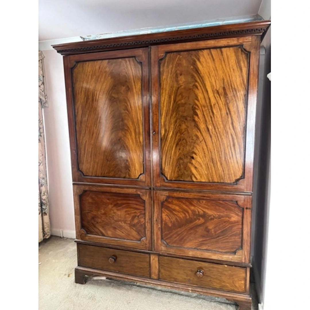 A flame mahogany wardrobe with panelled doors, two drawers u...