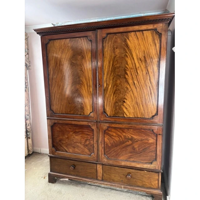 A flame mahogany wardrobe with panelled doors, two drawers u...