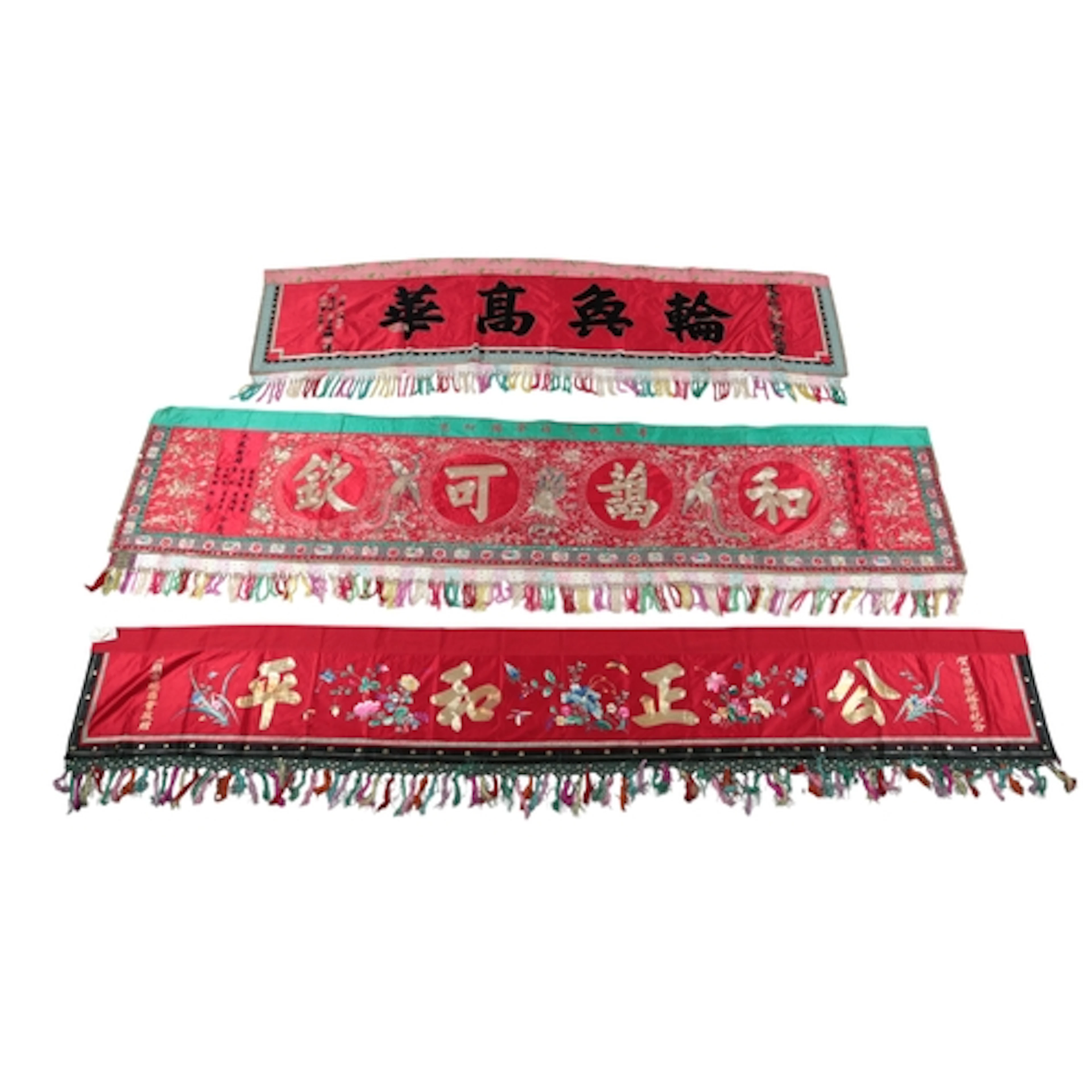 A group of three Chinese inscribed embroidered silk banners,...