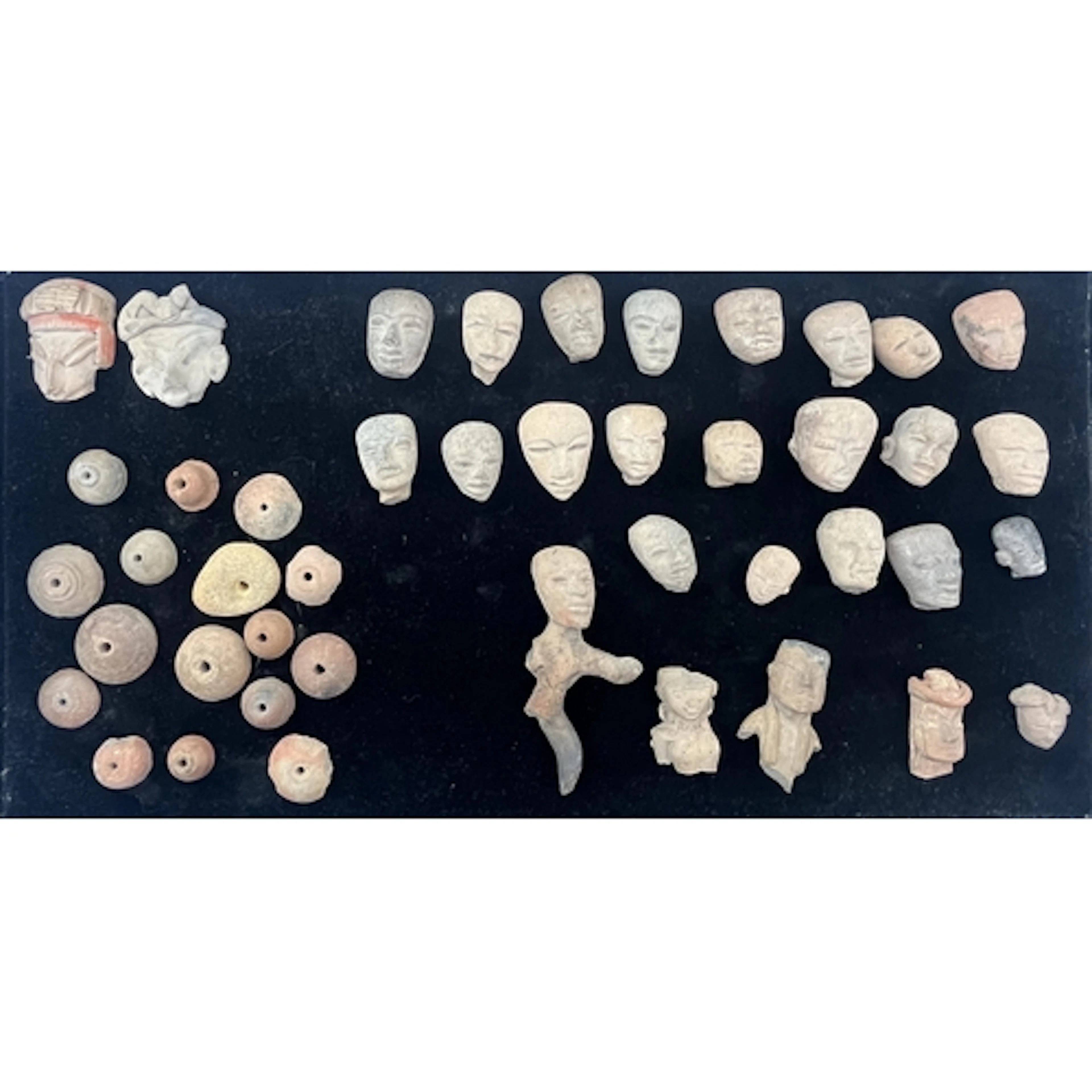 A group of pre-Colombian terracotta heads, a partial figure ...