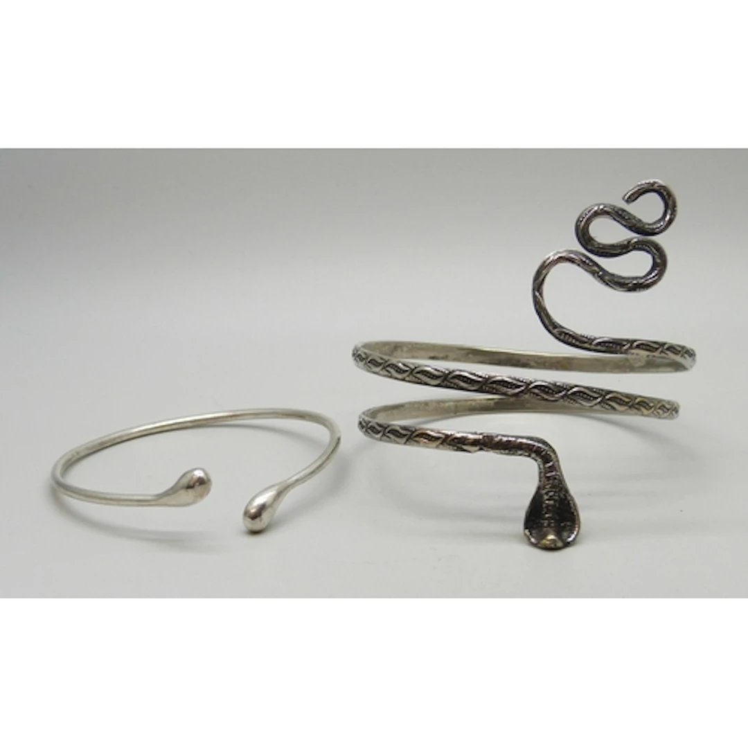 A silver plated snake design bangle, together with a silver ...