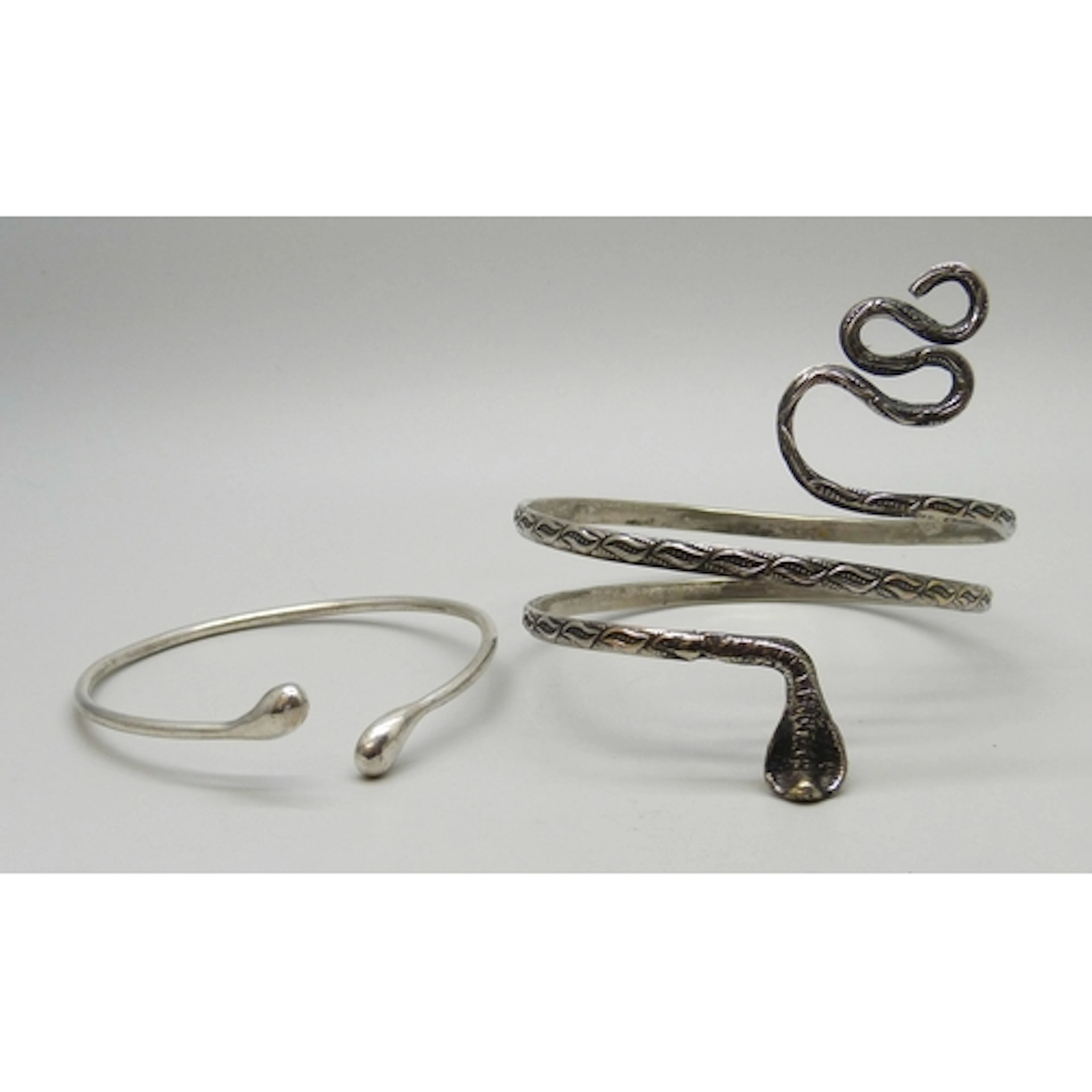 A silver plated snake design bangle, together with a silver ...