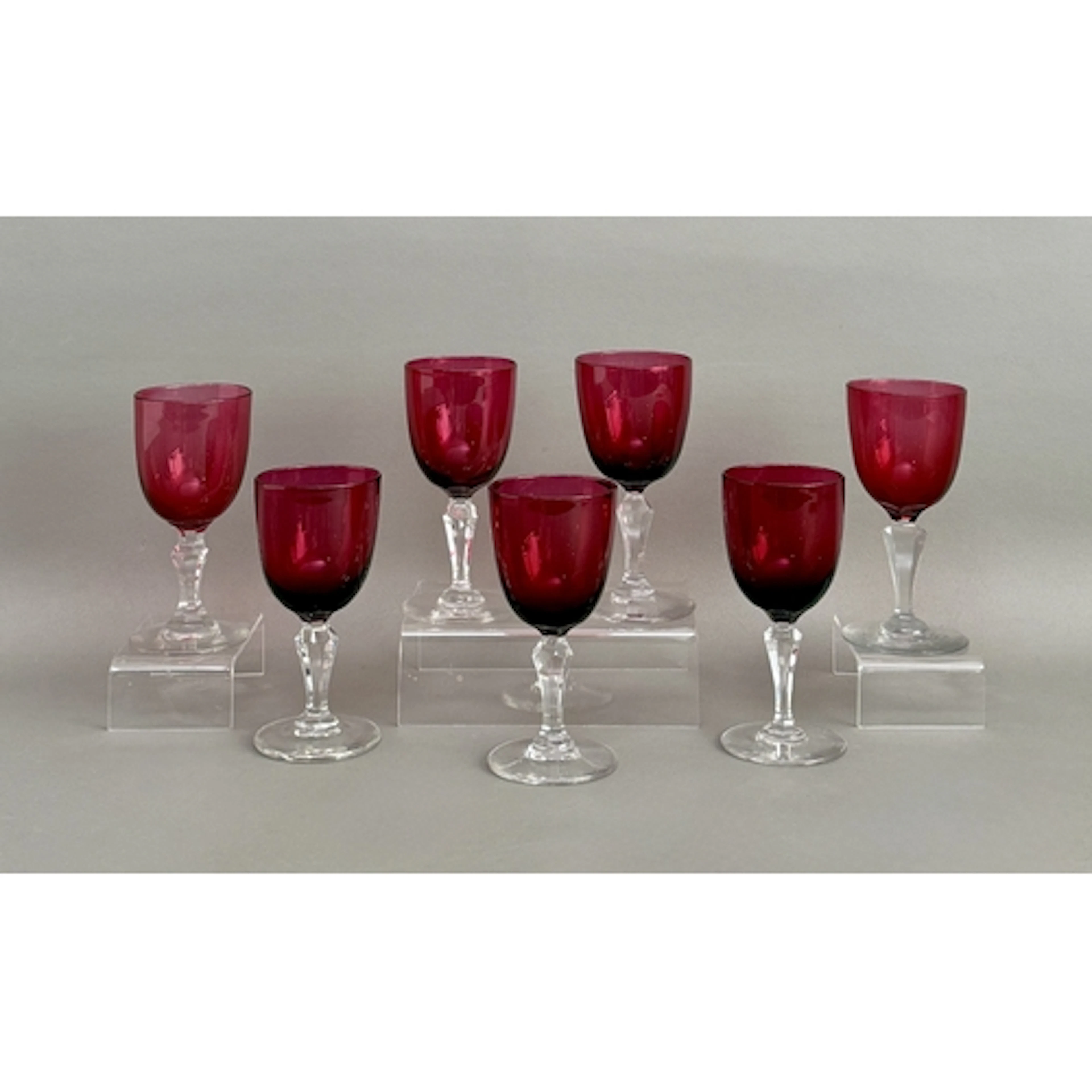 A set of seven cranberry glass wine glasses - late 19th / ea...