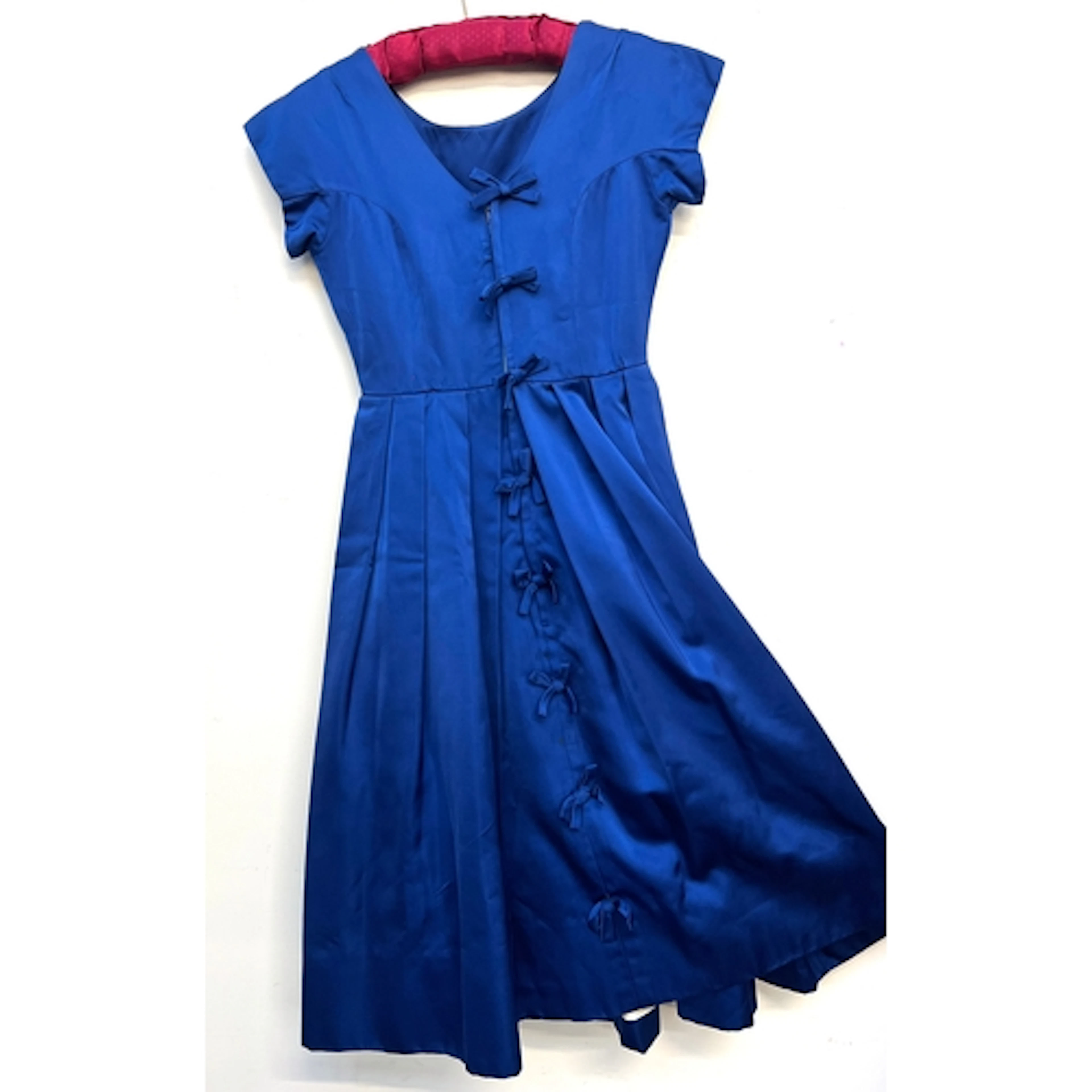 A vintage 1950s blue satin short sleeved dress with ribbon d...