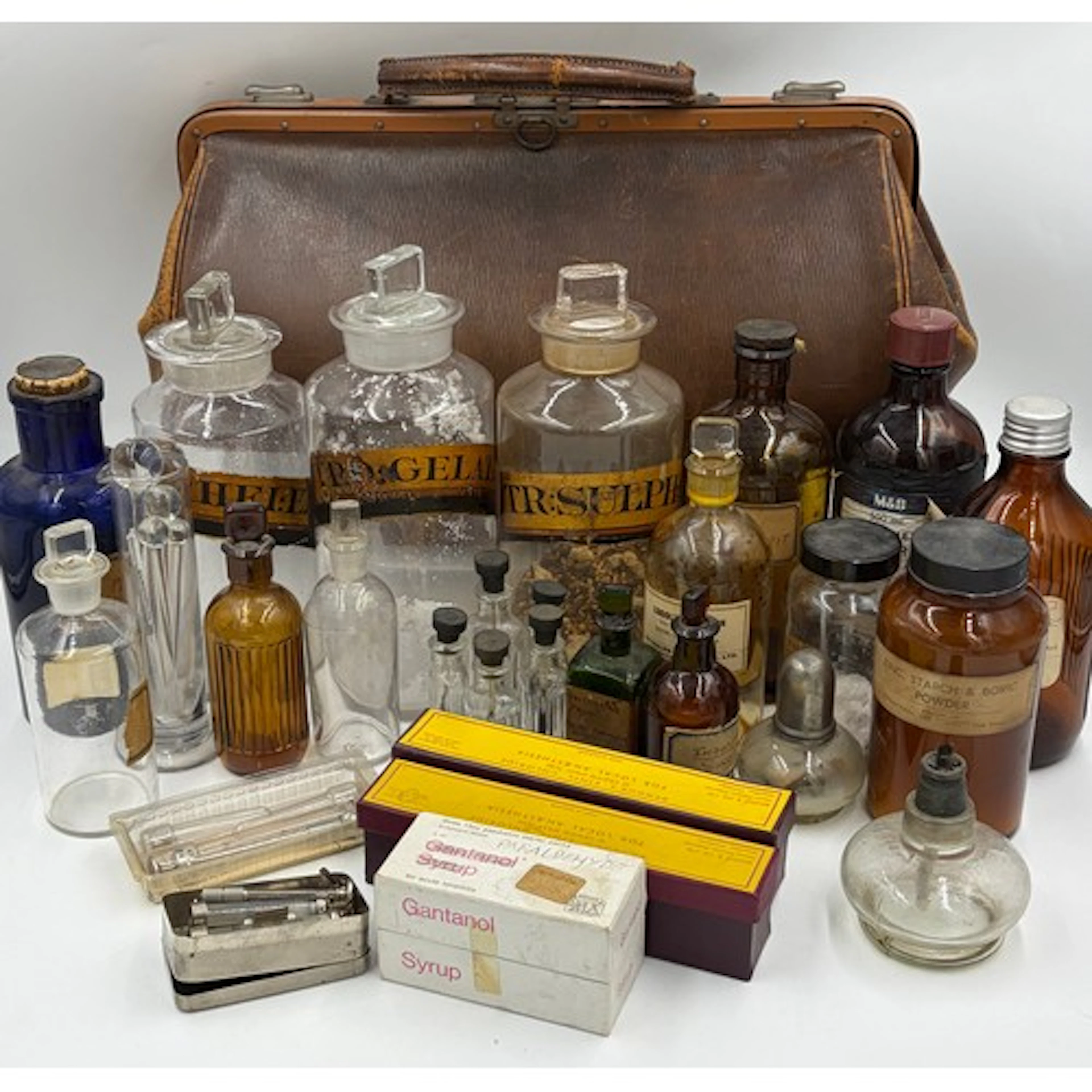 A Gladstone doctors bag together with a collection of pharma...