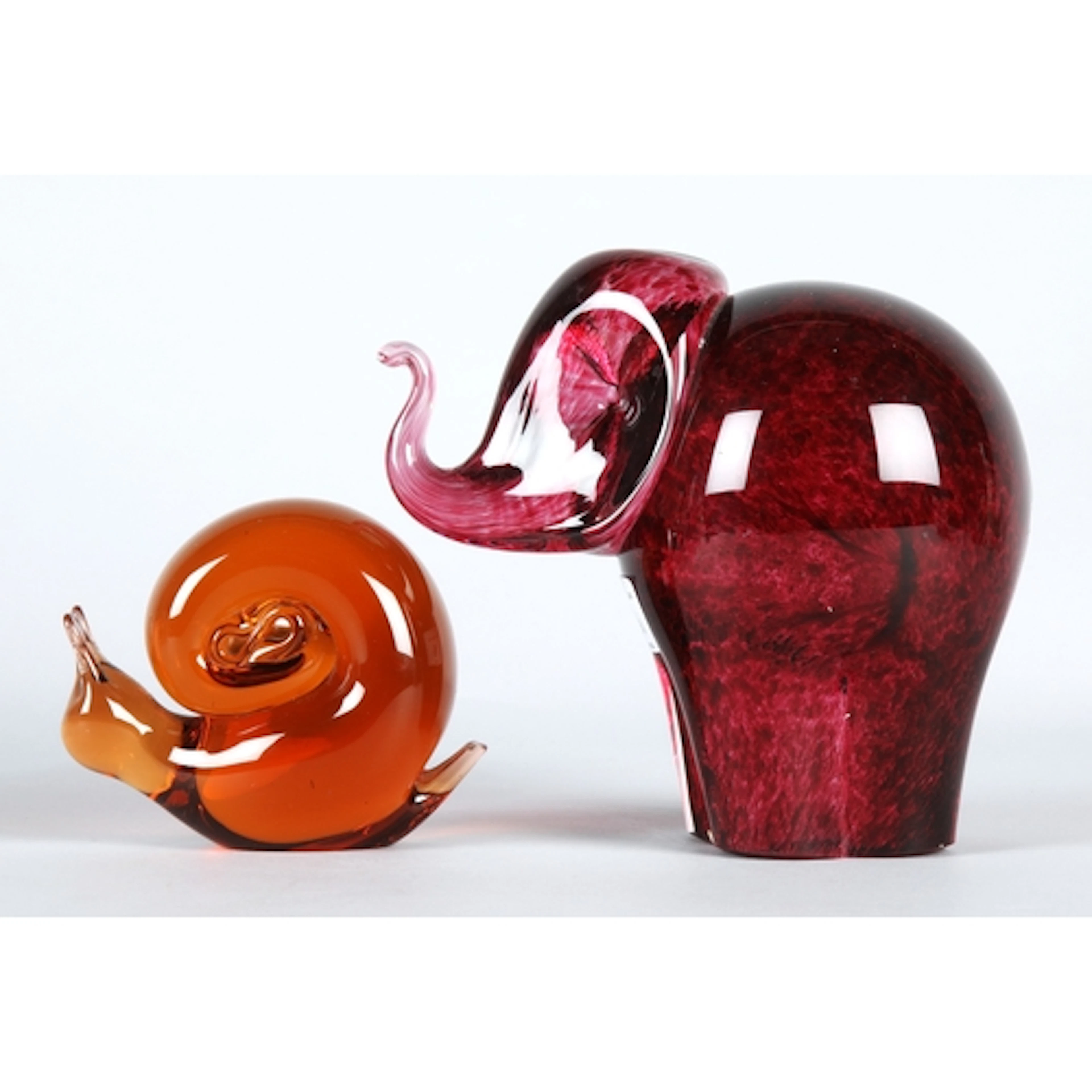 Wedgwood cranberry glass elephant sculpture with an art glas...