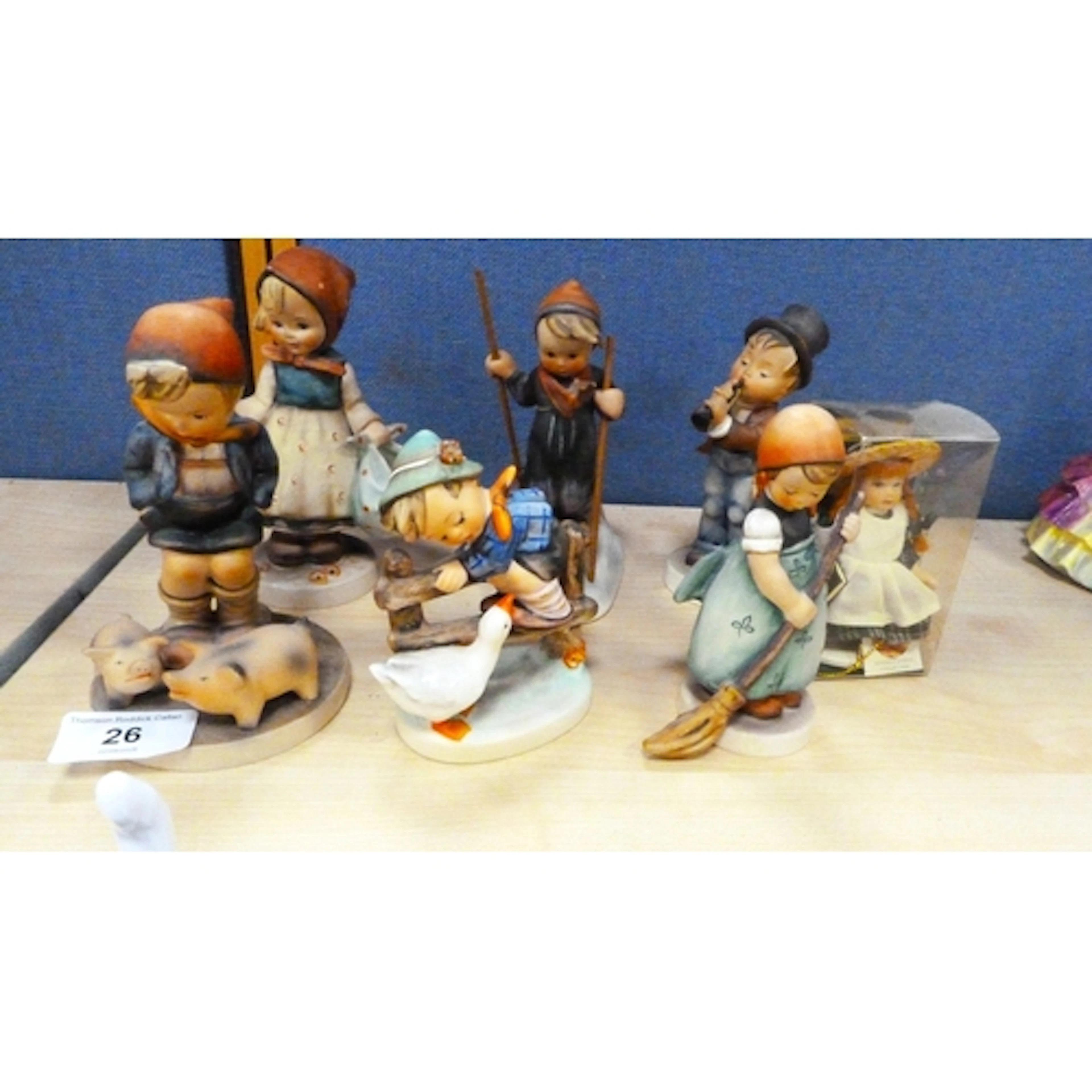 Six Hummel figures and porcelain doll.