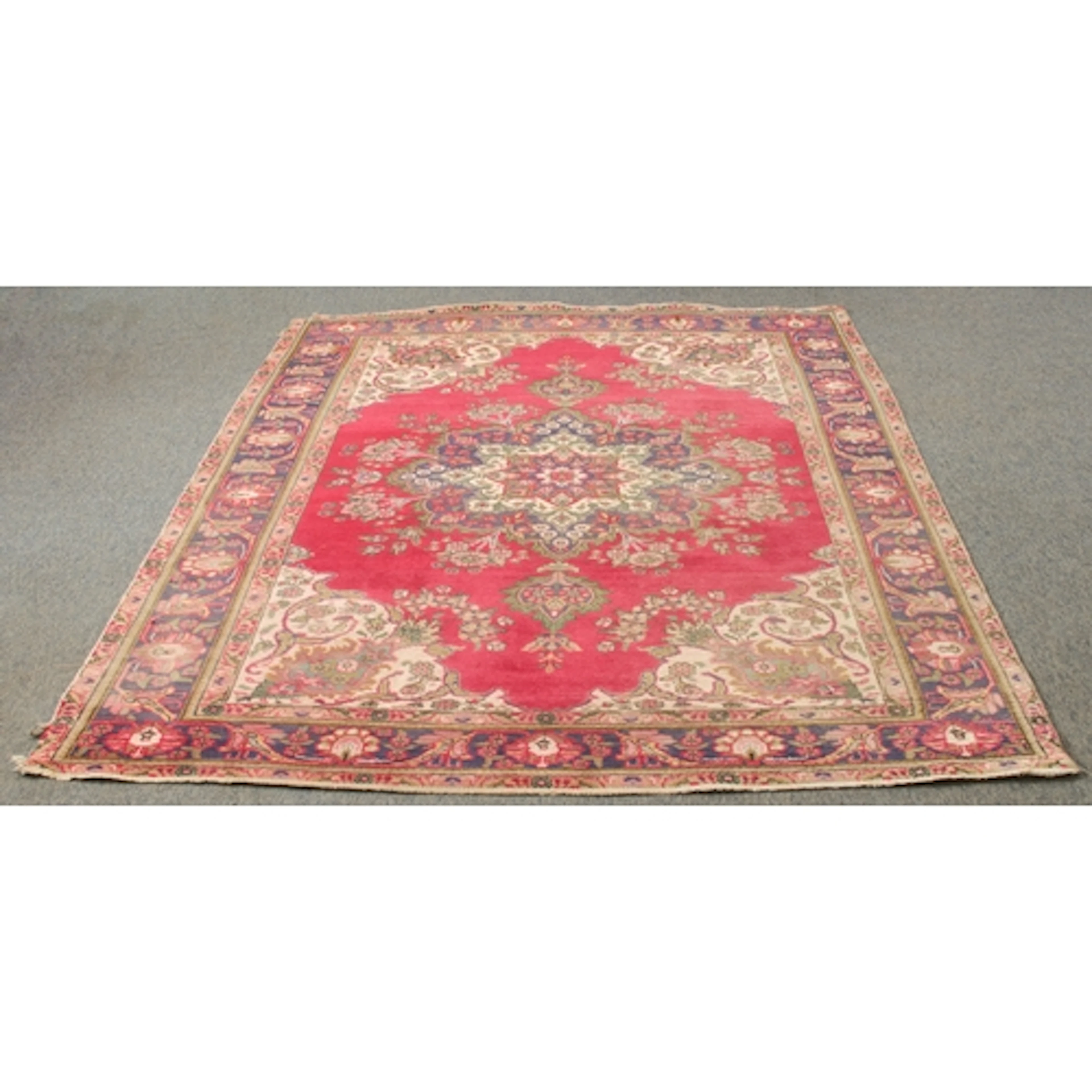 A large Persian hand-knotted wool rug, probably Tabriz - pro...