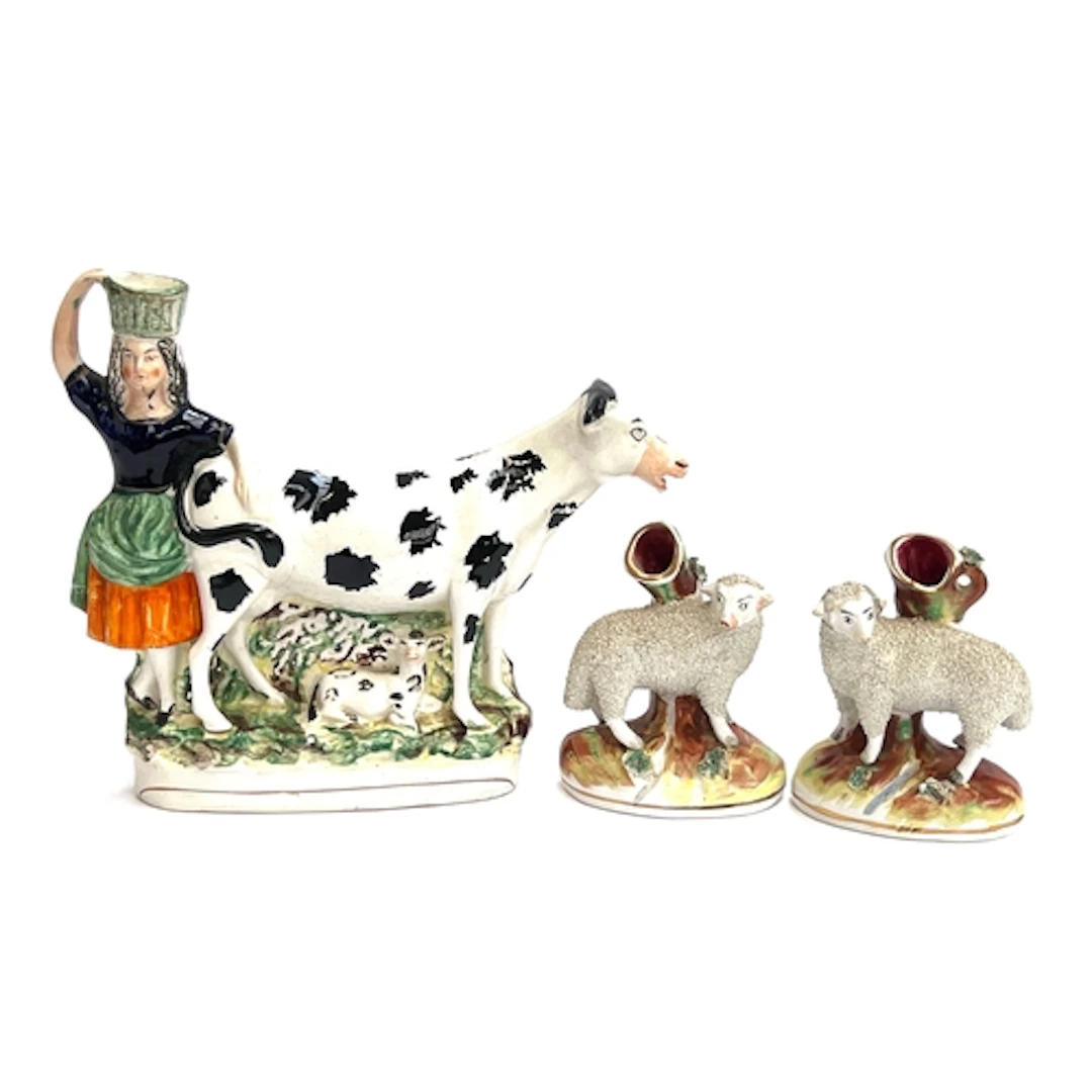 A Staffordshire flatback cow & milkmaid; together with a pai...