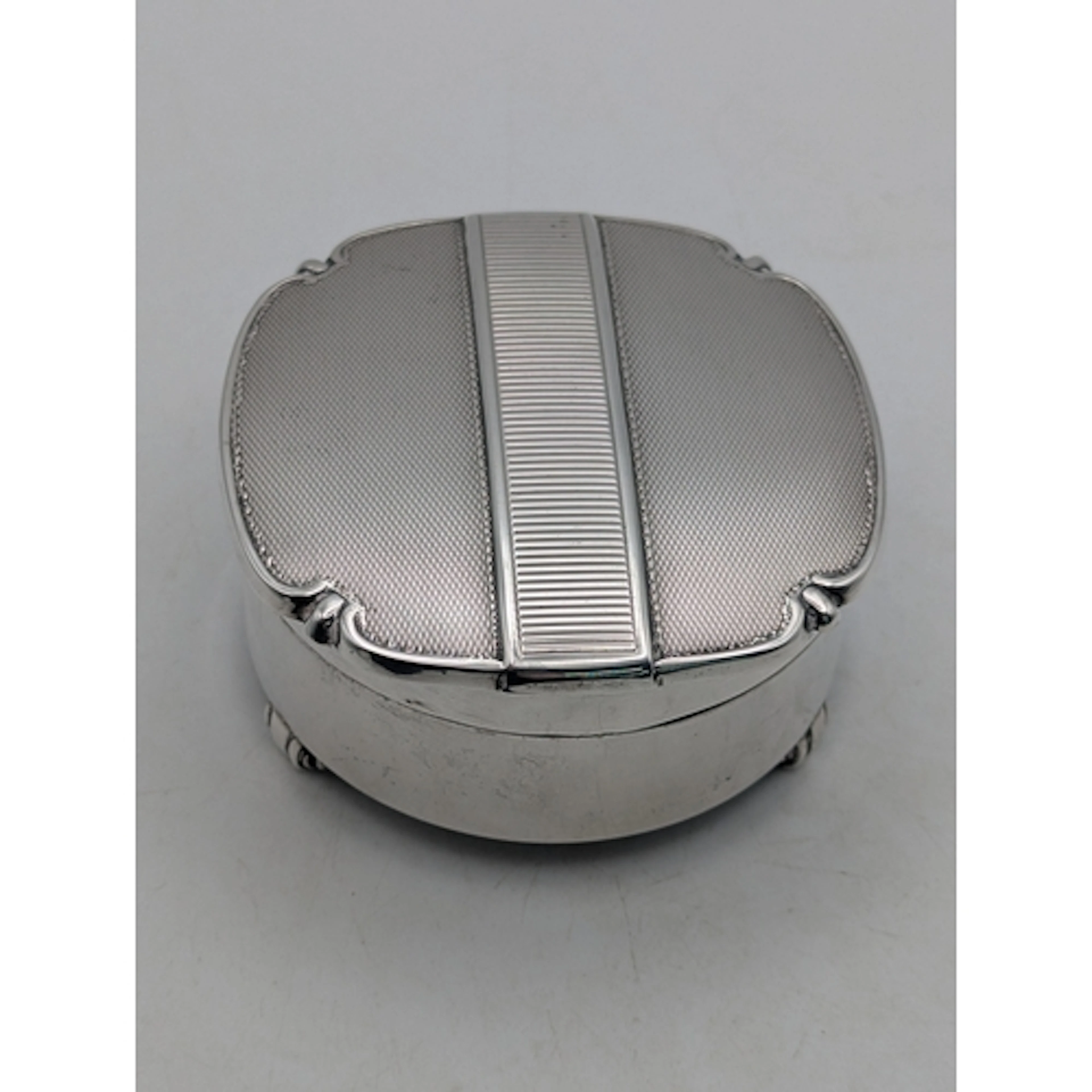 A silver ring box, hallmarked Birmingham 1953, having engine...