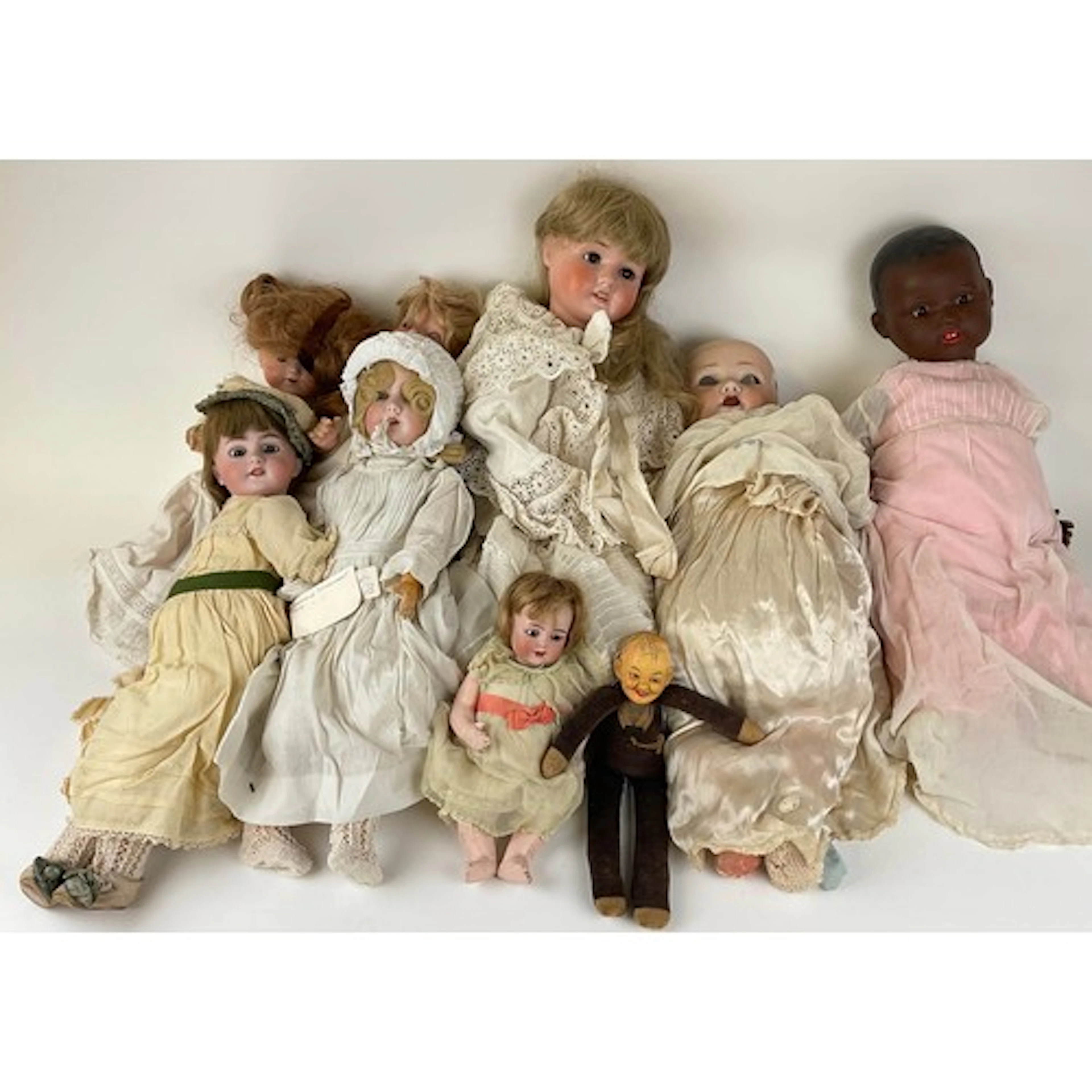 Dolls - an early 20th century bisque headed, soft bodied dol...