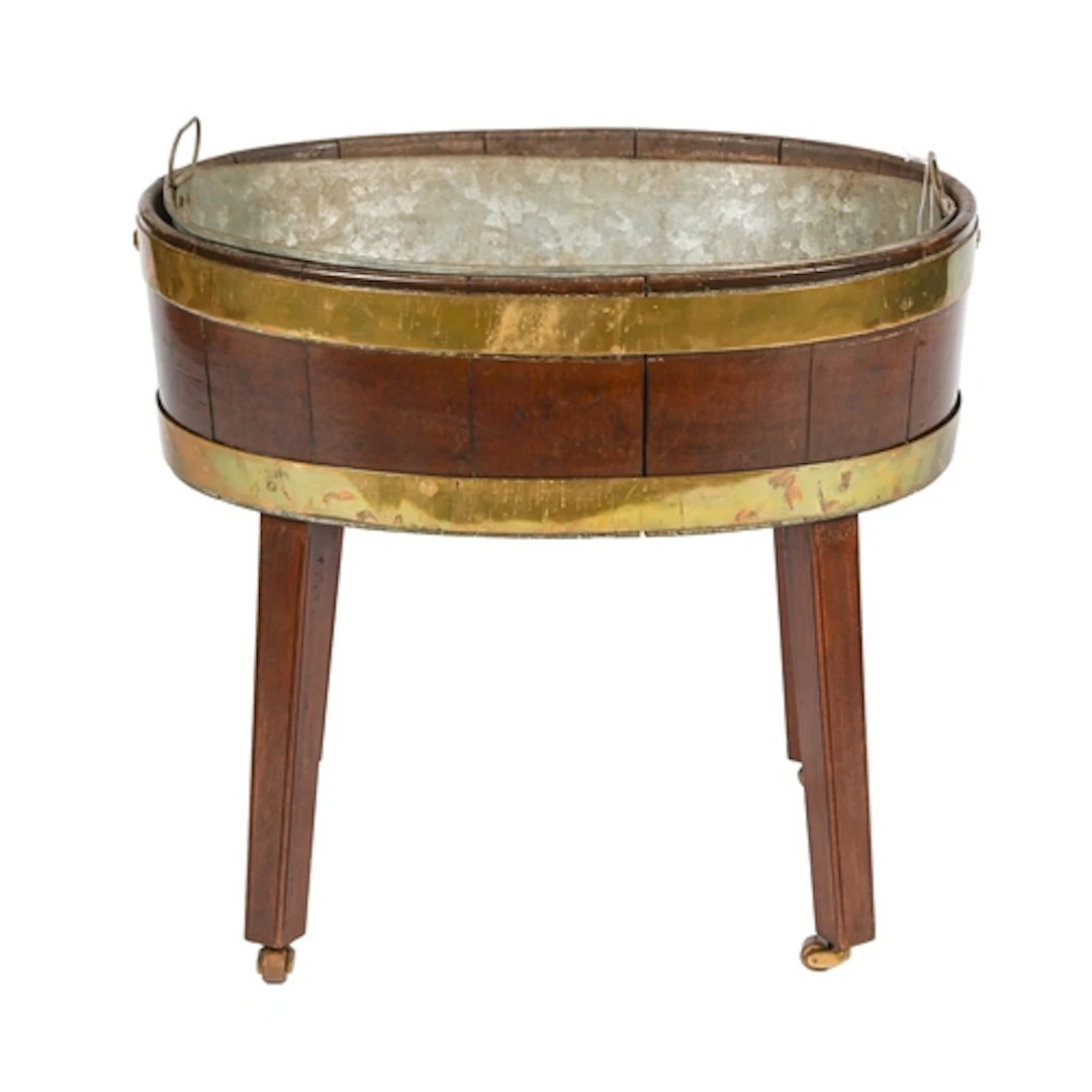 A George III brass bound oval mahogany wine cooler, on scrib...