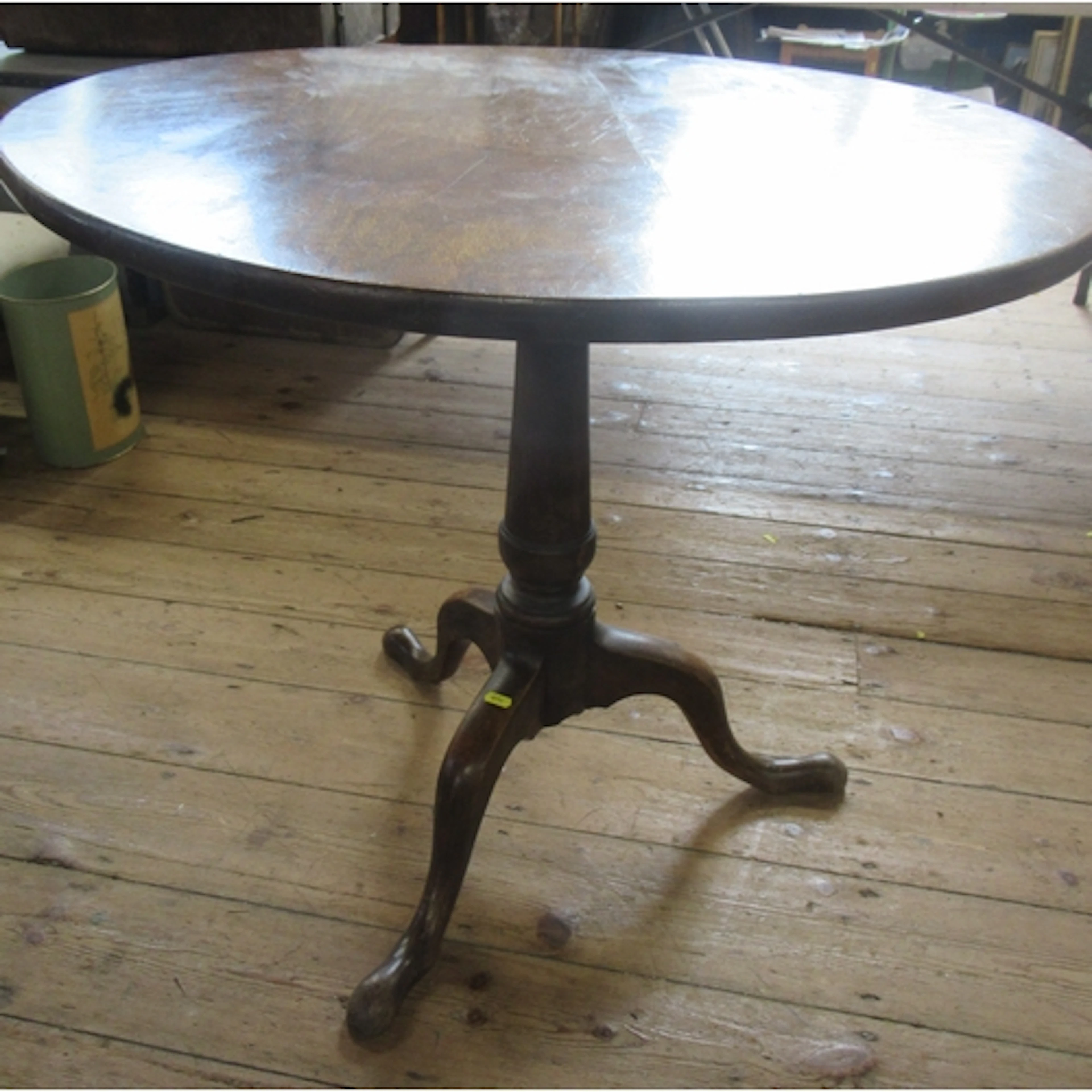 An antique oak tilt top tripod table, on turned column, with...