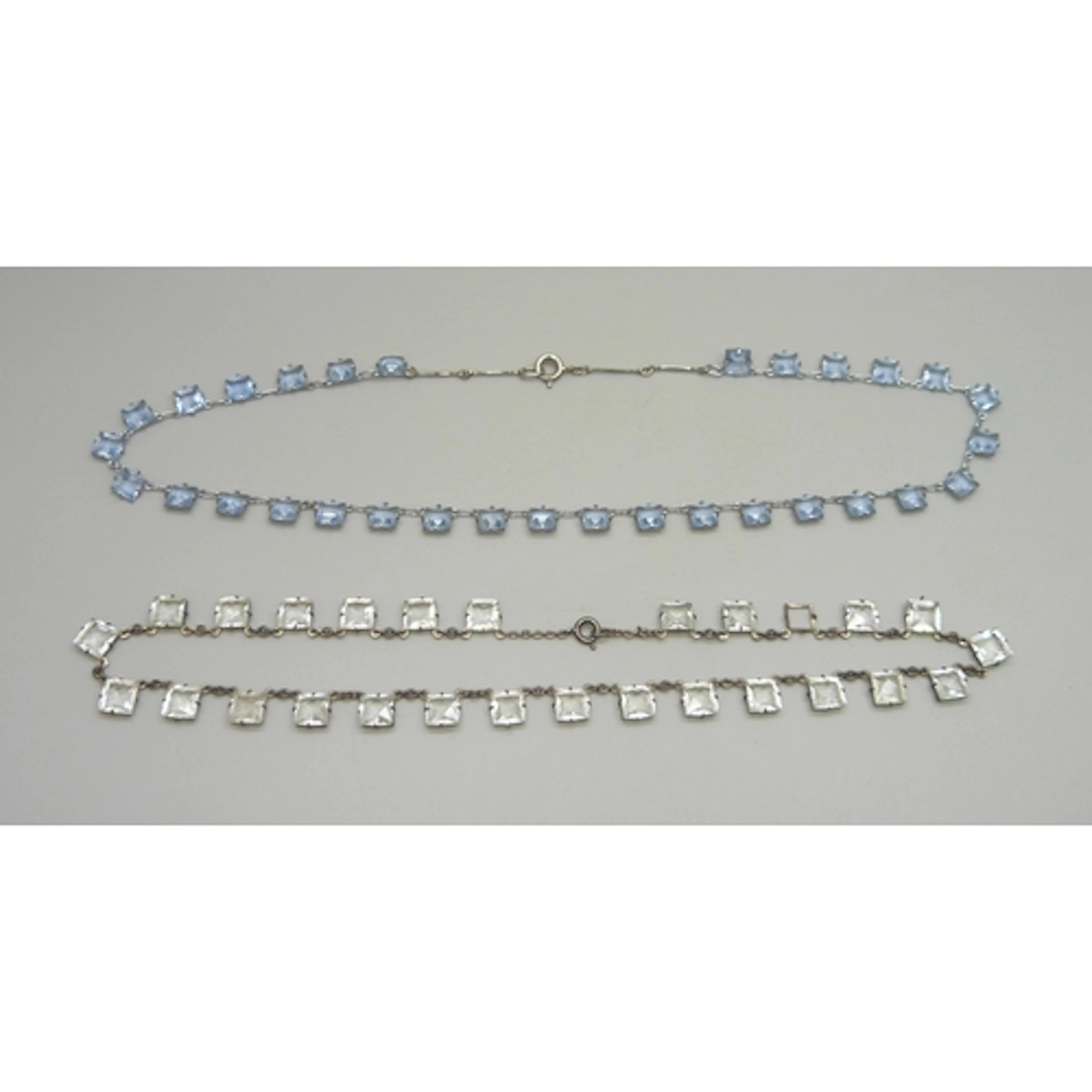 An Art Deco silver riviere necklace set with white paste sto...