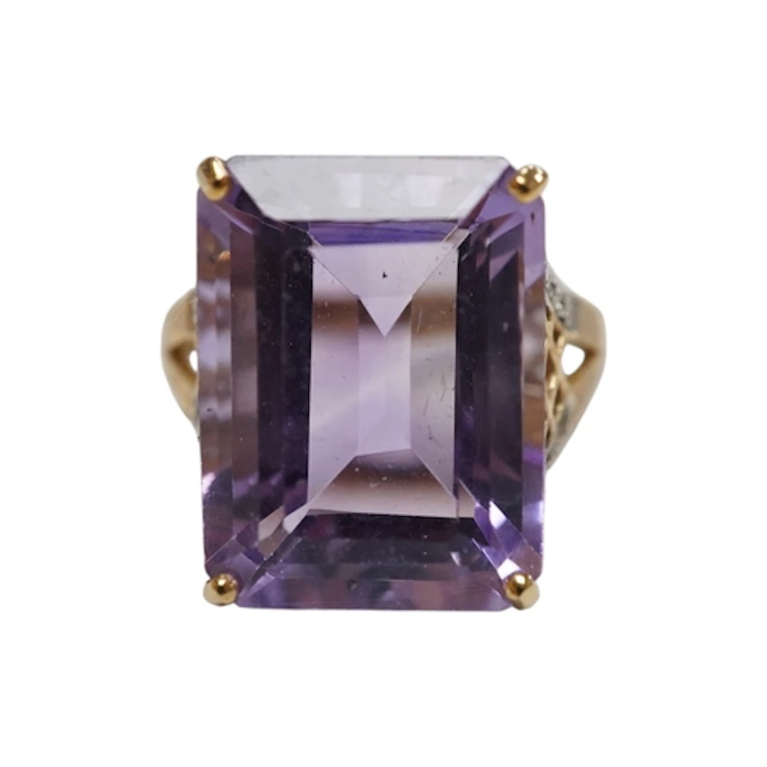 An amethyst and diamond ring, claw-set with a step-cut ameth...