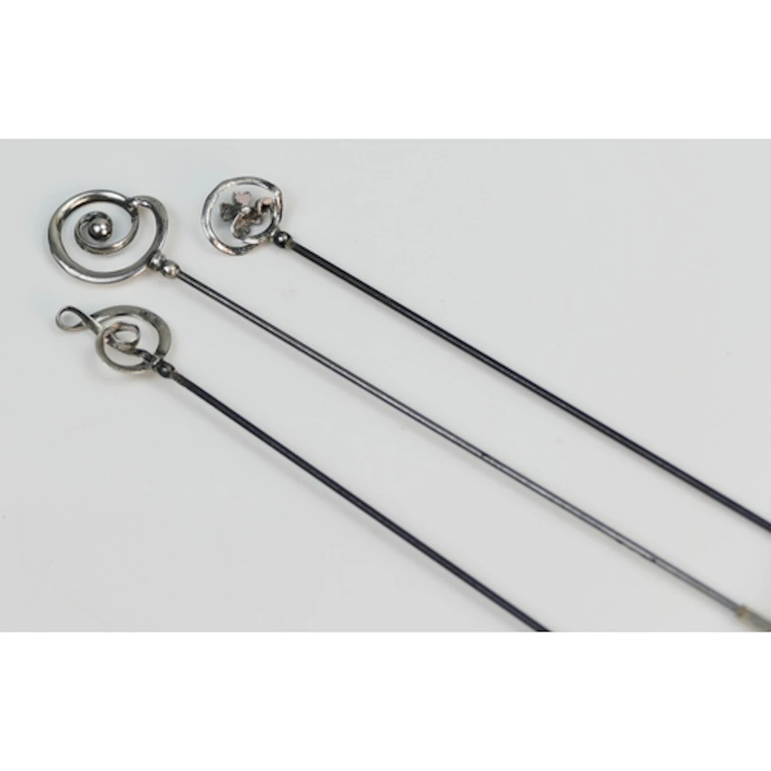 Three silver mounted Charles Horner hat pins, one hallmarked...