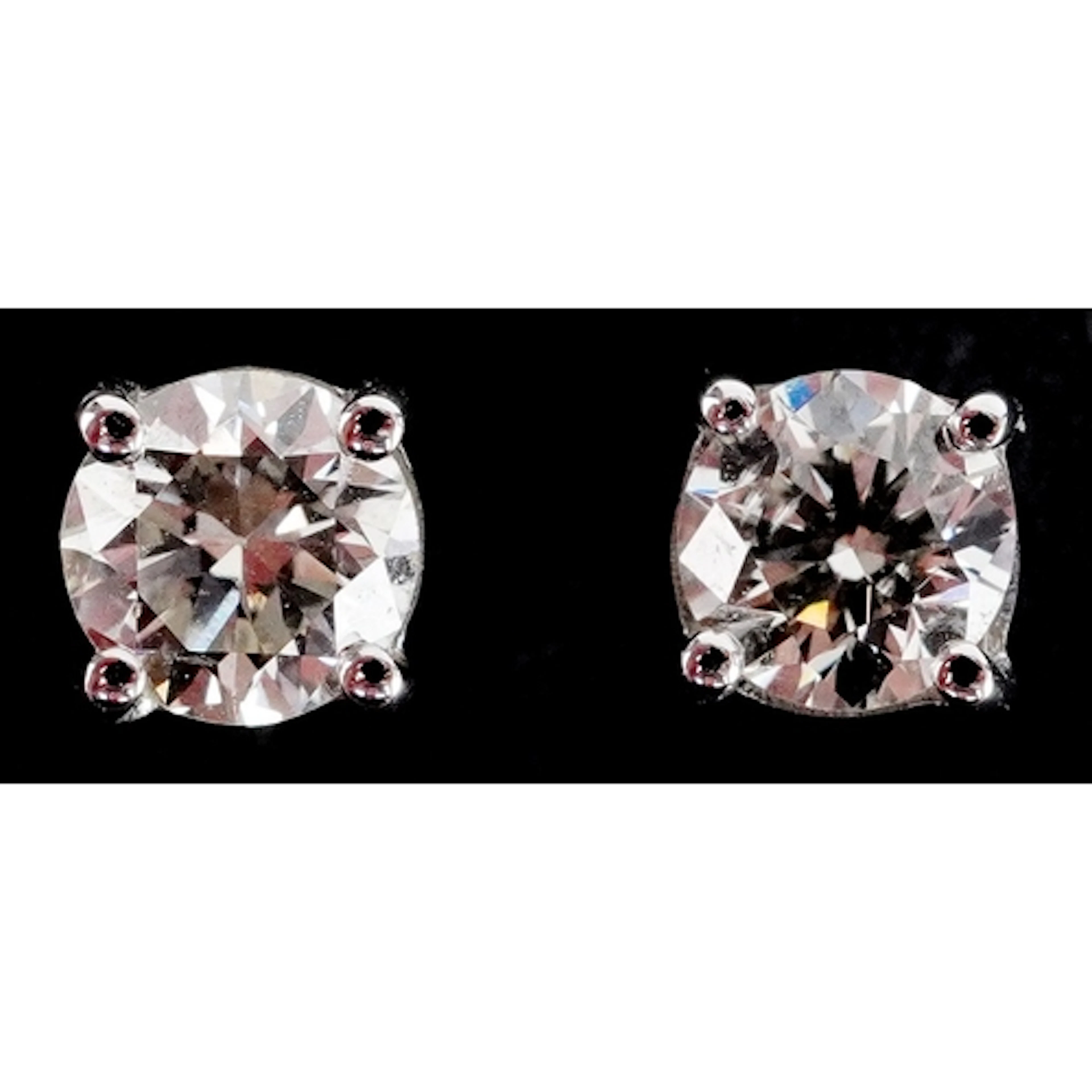 Pair of 18ct white gold diamond solitaire stud earrings, tot...