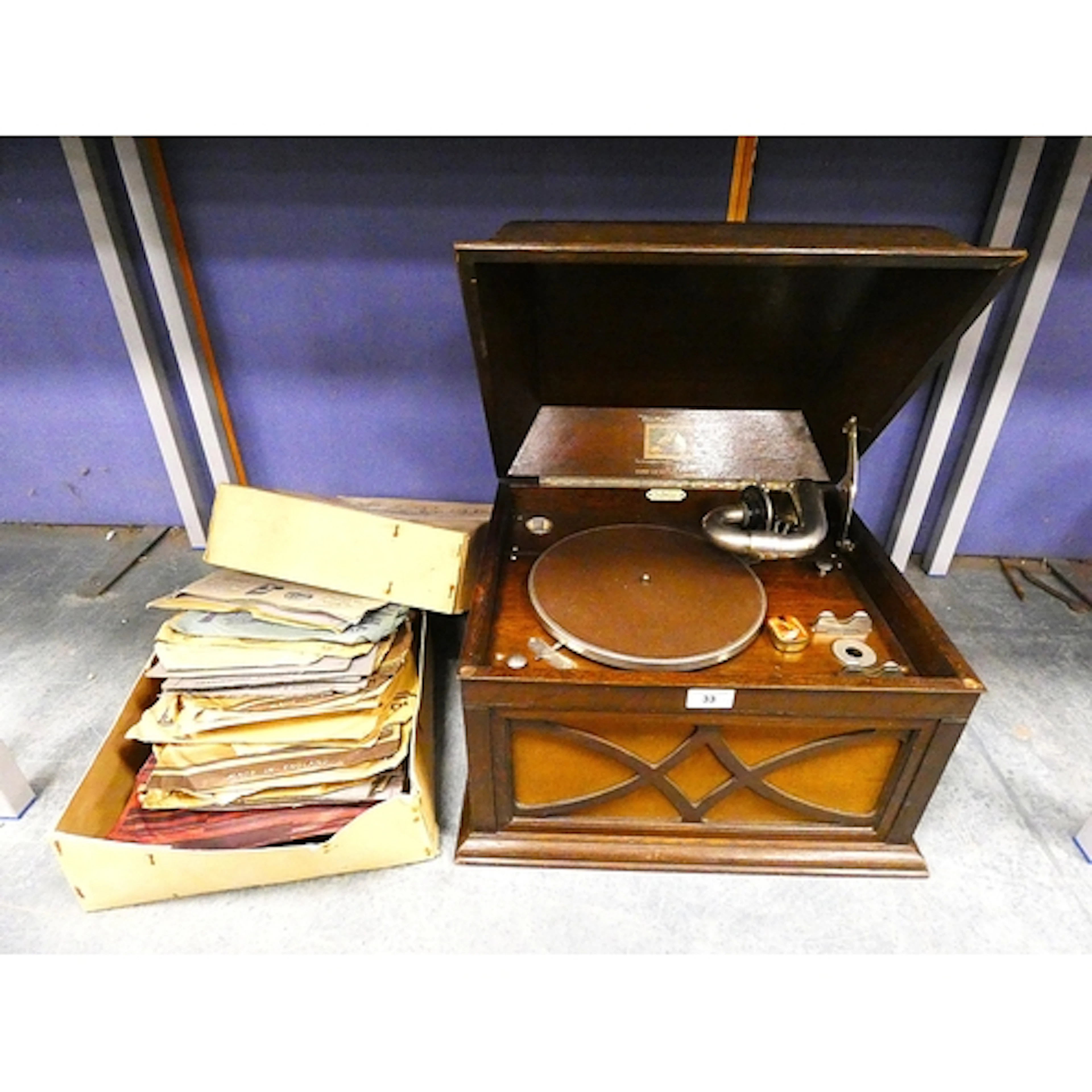 HMV portable gramaphone with collection of vinyl.