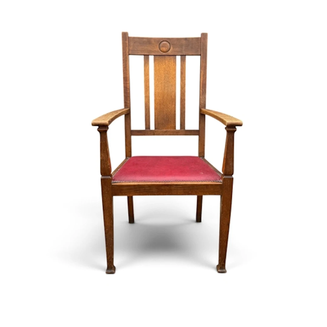 AN ARTS AND CRAFTS OAK OPEN ARM ELBOW CHAIR The seat upholst...