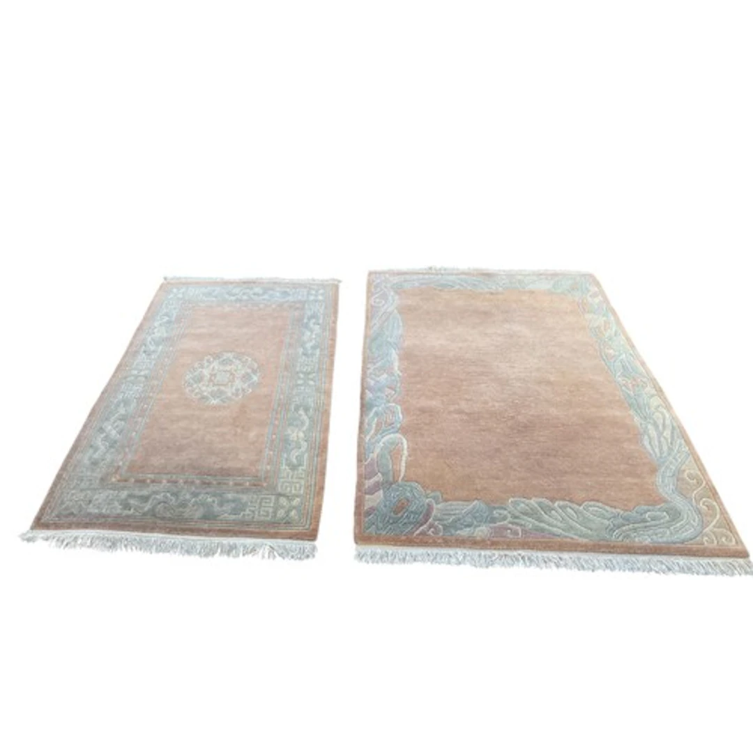 Pair of Chinese rugs featuring a pale pink/peach background ...