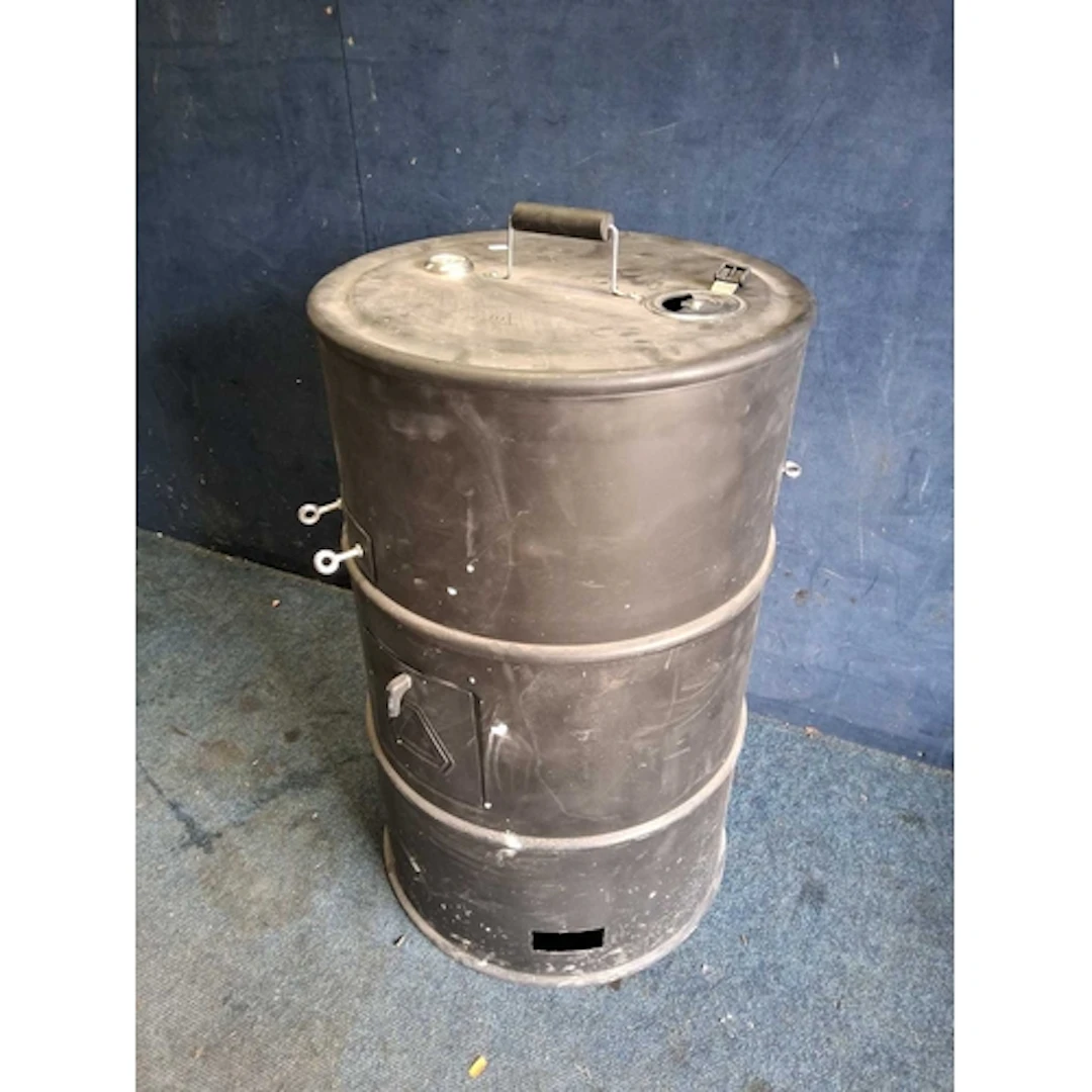 A BARREL BARBECUE with temperature gauge to lid, concealing ...